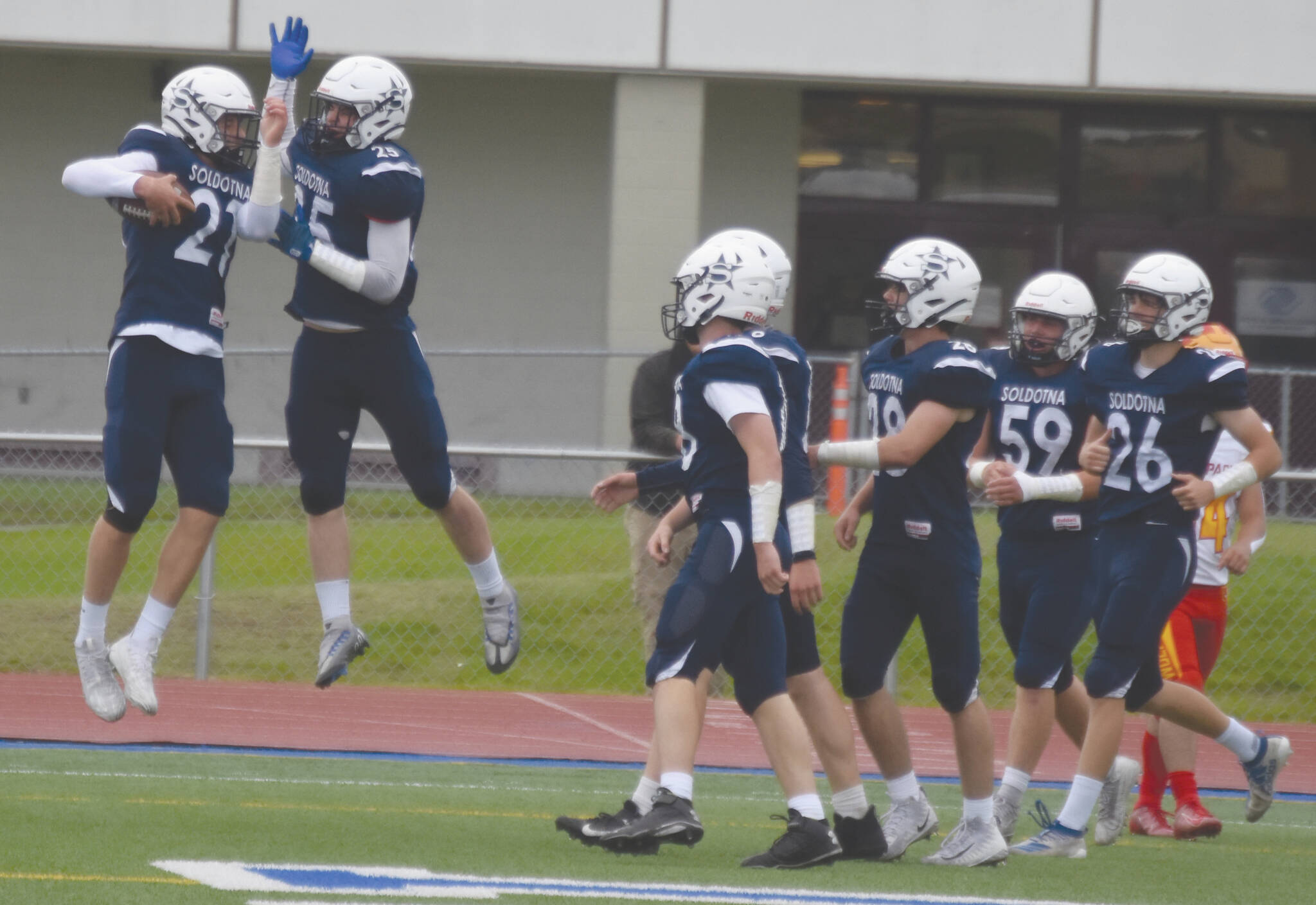 Brayden Taylor and Gehret Medcoff celebrate a touchdown on Friday, Aug. 26, 2022, at Justin Maile Field at Soldotna High School in Soldotna, Alaska. (Jake Dye/Peninsula Clarion)