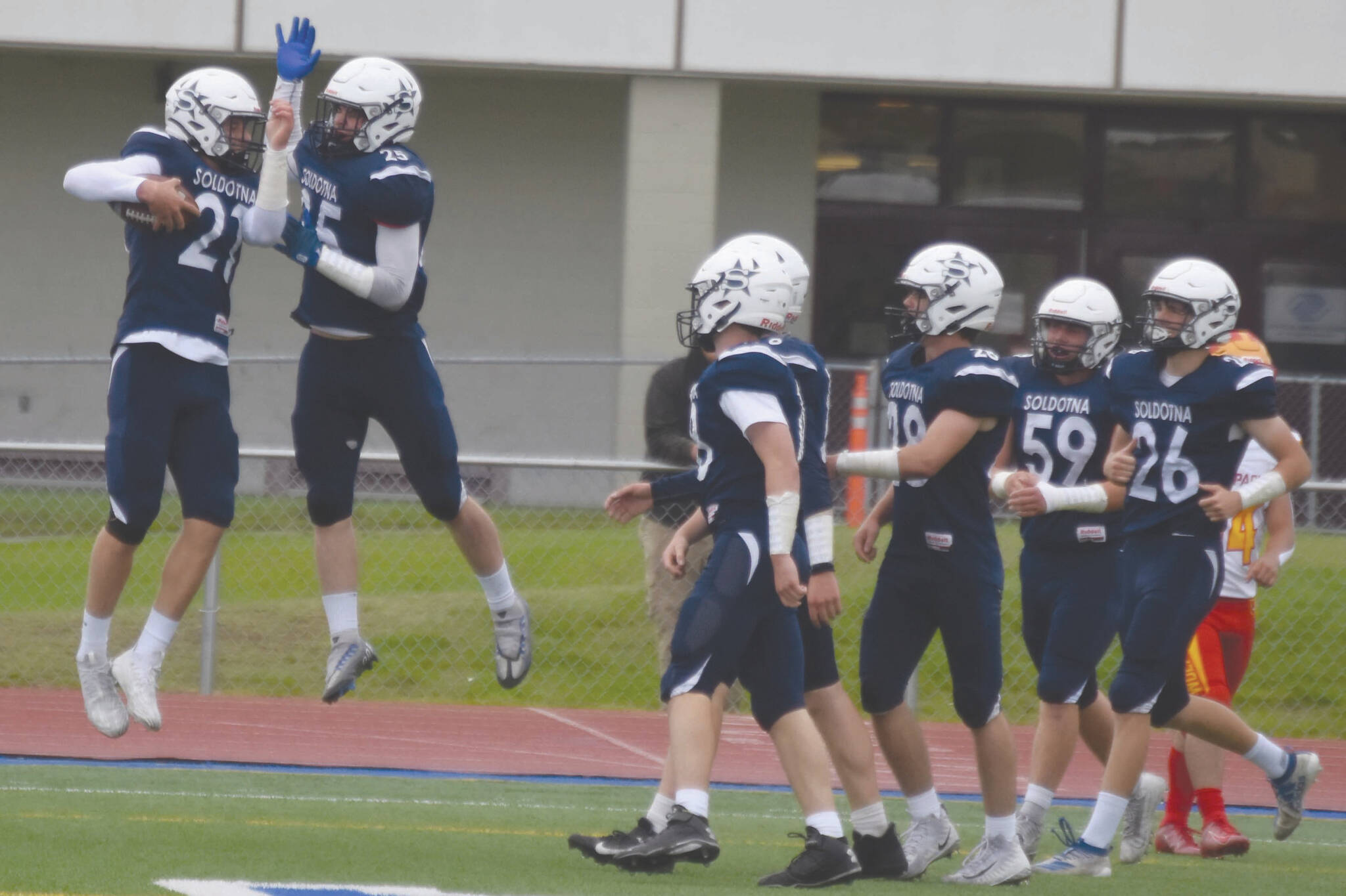 Brayden Taylor and Gehret Medcoff celebrate a touchdown on Friday, Aug. 26, 2022, at Justin Maile Field at Soldotna High School in Soldotna, Alaska. (Jake Dye/Peninsula Clarion)