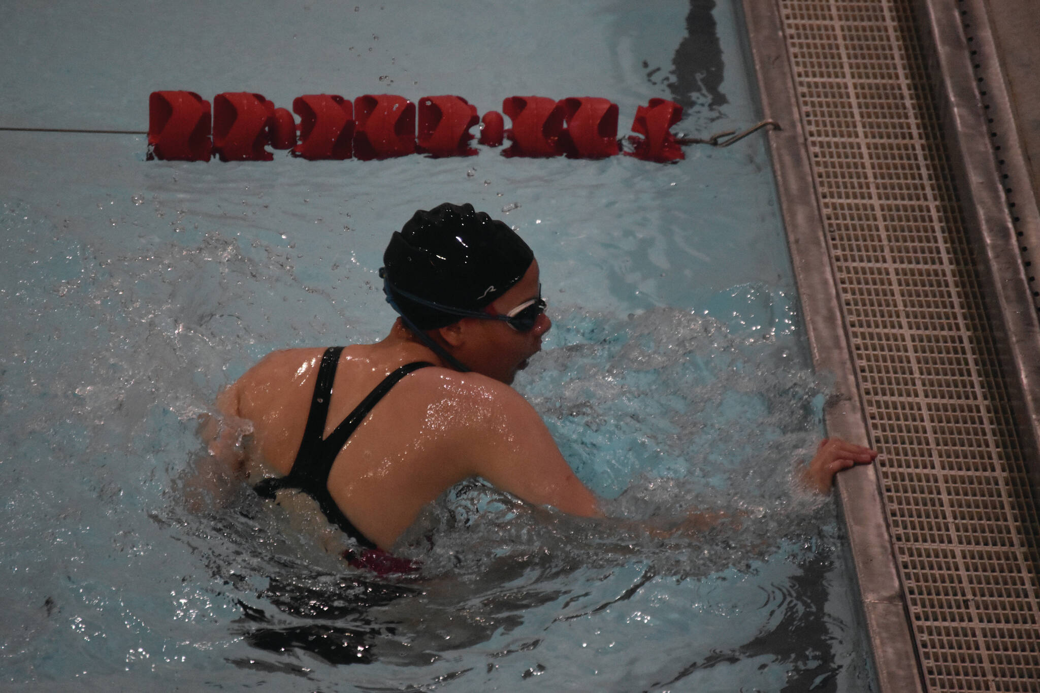 Michelle Duffield, of Kenai, performs an open turn while swimming her leg of the 200-yard medley relay at Kenai Central High School in Kenai, Alaska, on Aug. 27, 2022. (Jake Dye/Peninsula Clarion)