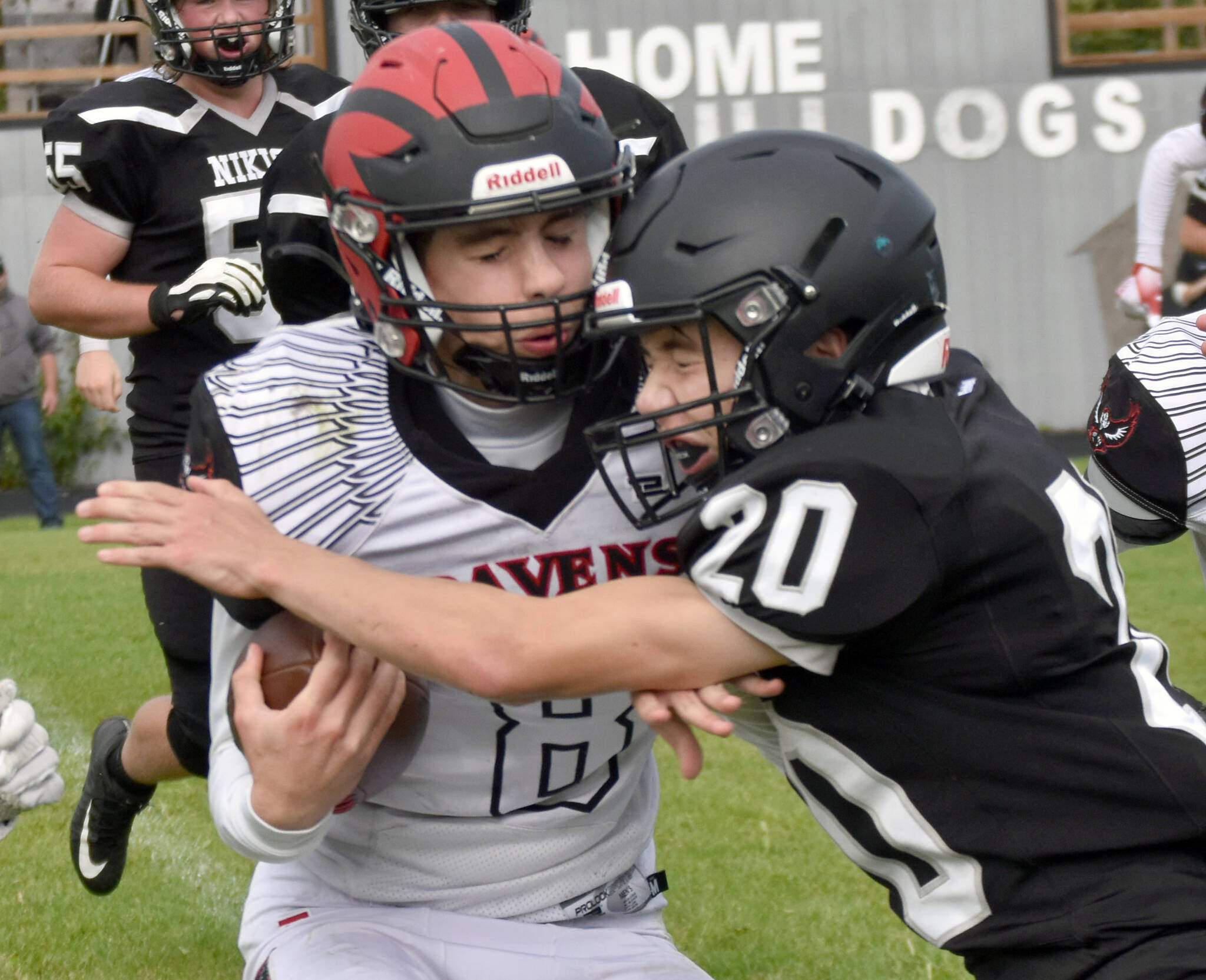 Eielson’s Evan Brown is tackled by Nikiski’s Wyatt Maguire on Saturday, Aug. 27, 2022, at Nikiski High School in Nikiski, Alaska. (Photo by Jeff Helminiak/Peninsula Clarion)