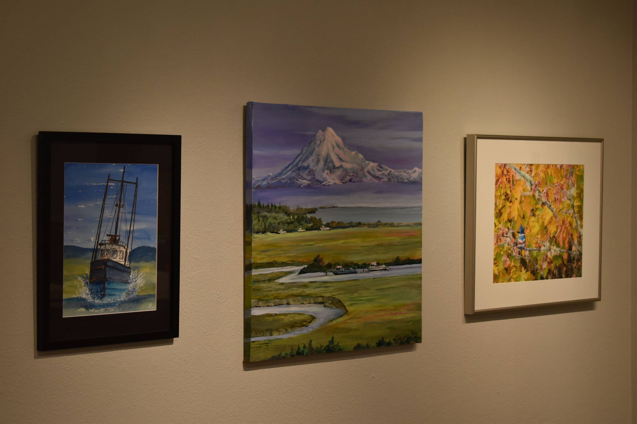 Artwork donated for the Harvest Auction hangs at the Kenai Art Center on Tuesday, Aug. 30, 2022, in Kenai, Alaska. (Jake Dye/Peninsula Clarion)