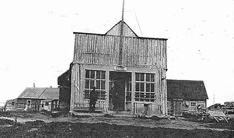 Photo courtesy of the Kenai Historical Society 
This is the only known photo of Peter F. (“Frenchy”) Vian and William N. (“Bill”) Dawson together. They were photographed standing on the porch of their Kenai store in about 1911-12.