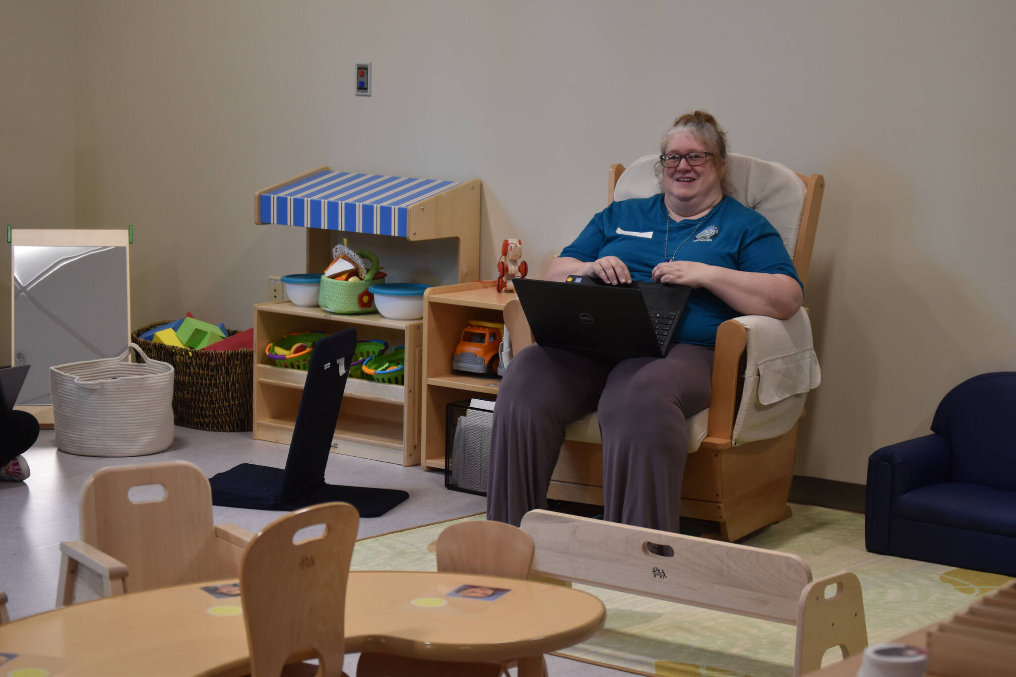 One of the educators for the toddler program at the Kahtnuht’ana Duhdeldiht Campus prepares in a classroom on Thursday, Sept. 1, 2022, in Kenai, Alaska. (Jake Dye/Peninsula Clarion)