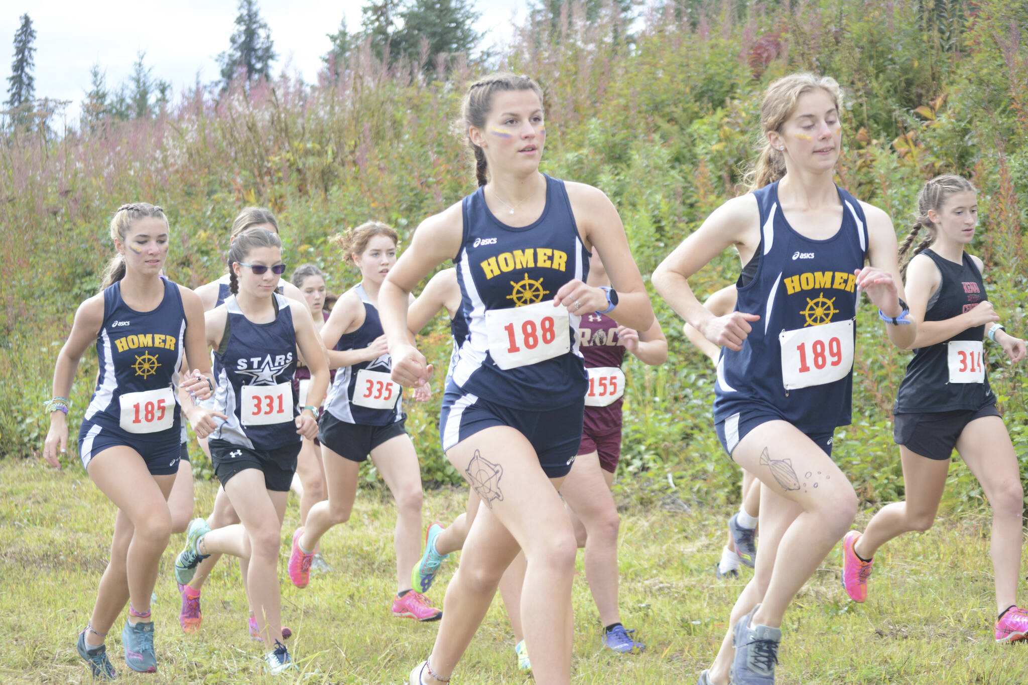 The girls cross-country runners take off at the start of the Homer Invite on Friday, Sept. 2, 2022, at the Lookout Mountain Trails near Homer, Alaska. (Photo by Michael Armstrong/Homer News)