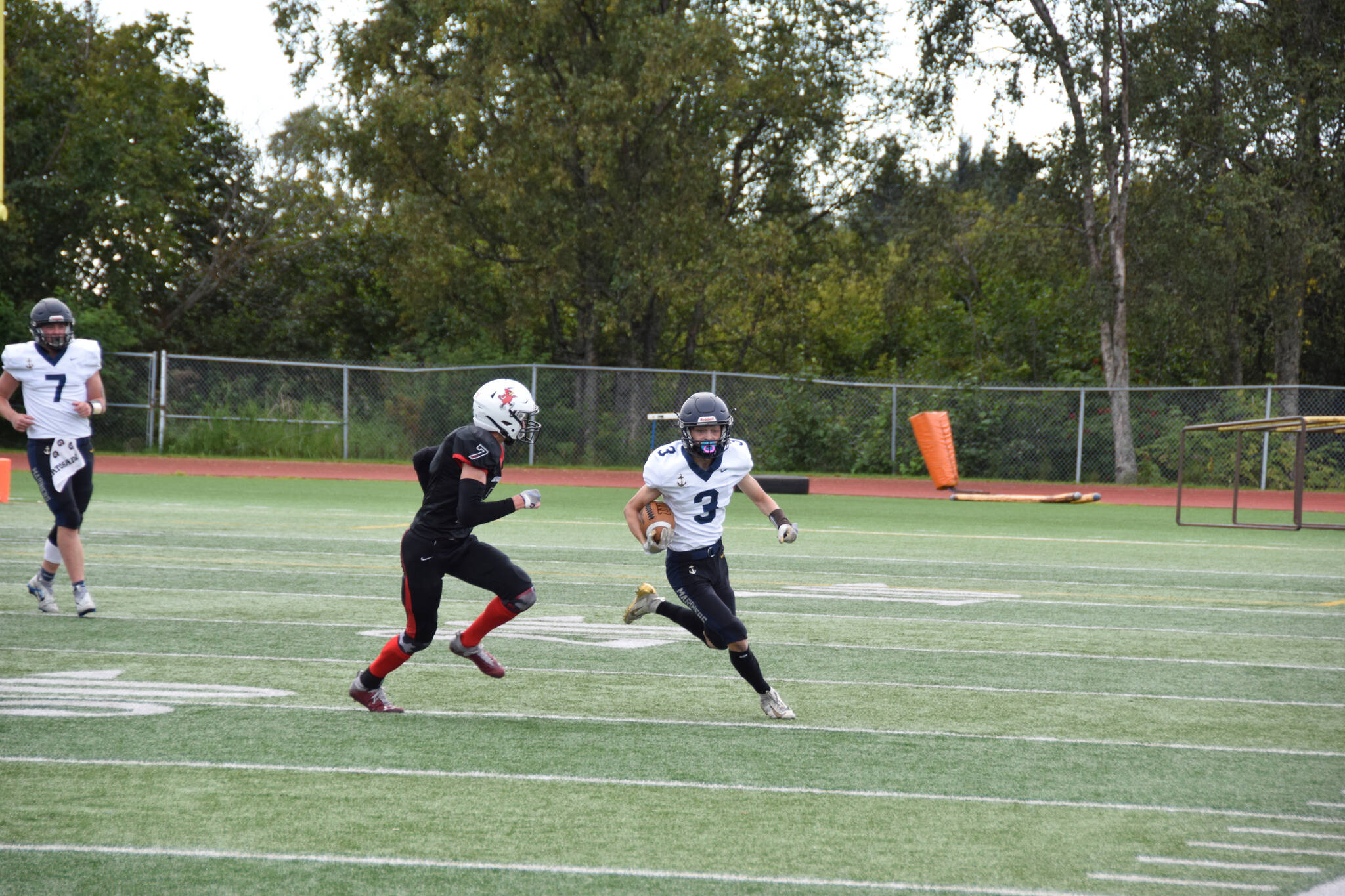 Homer wide receiver Jonah Martin carries the ball upfield on Saturday, Sep. 3, at the Homer High School Field in Homer, Alaska. (Photo by Charlie Menke/ Homer News)