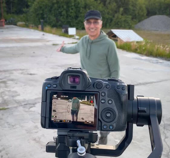 Joe Rizzo is seen on a shoot of “The Show Must Go On,” a feature-length documentary about fundraising efforts to rebuild after a 2021 fire destroyed the Triumvirate Theatre’s playhouse, at the site of the fire in Nikiski. (Photo courtesy Joe Rizzo)