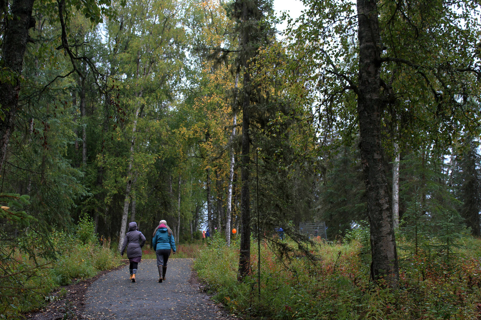 Visitors walk toward the grand opening and dedication ceremony for the Kenai Peninsula Peace Crane Garden Trails on Thursday, Sept. 8, 2022, in Soldotna, Alaska. (Ashlyn O’Hara/Peninsula Clarion)