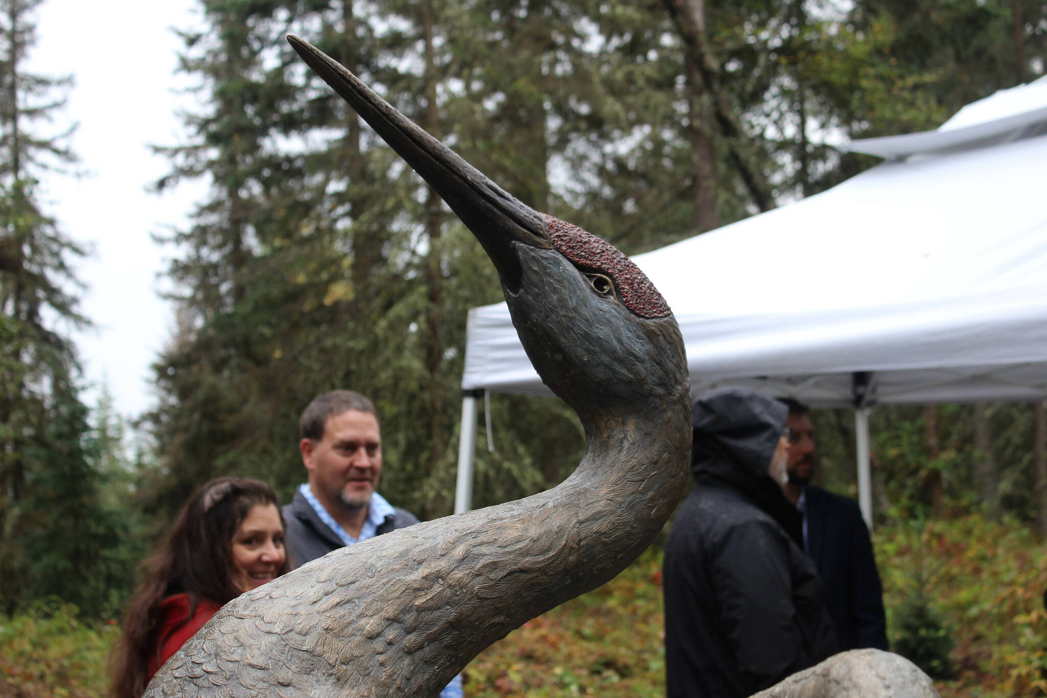 Visitors look at a peace crane statue unveiled as part of the grand opening and dedication of the Kenai Peninsula Peace Crane Garden Trails on Thursday, Sept. 8, 2022, in Soldotna, Alaska. (Ashlyn O’Hara/Peninsula Clarion)