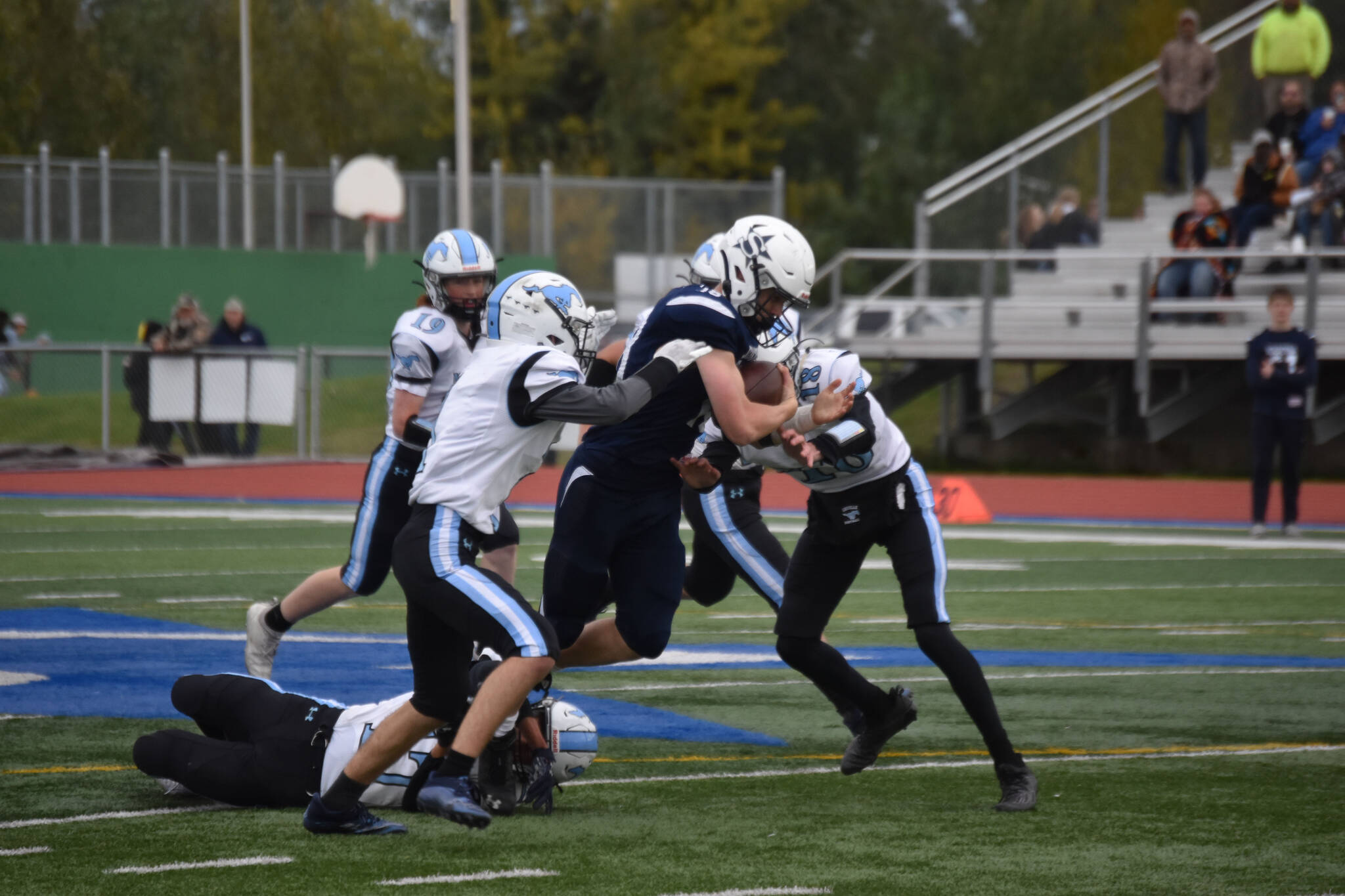 Zac Buckbee holds the ball while trying to push through Chugiak defenders at Justin Maile Field in Soldotna, Alaska on Sept. 9, 2022 (Jake Dye/Peninsula Clarion)
