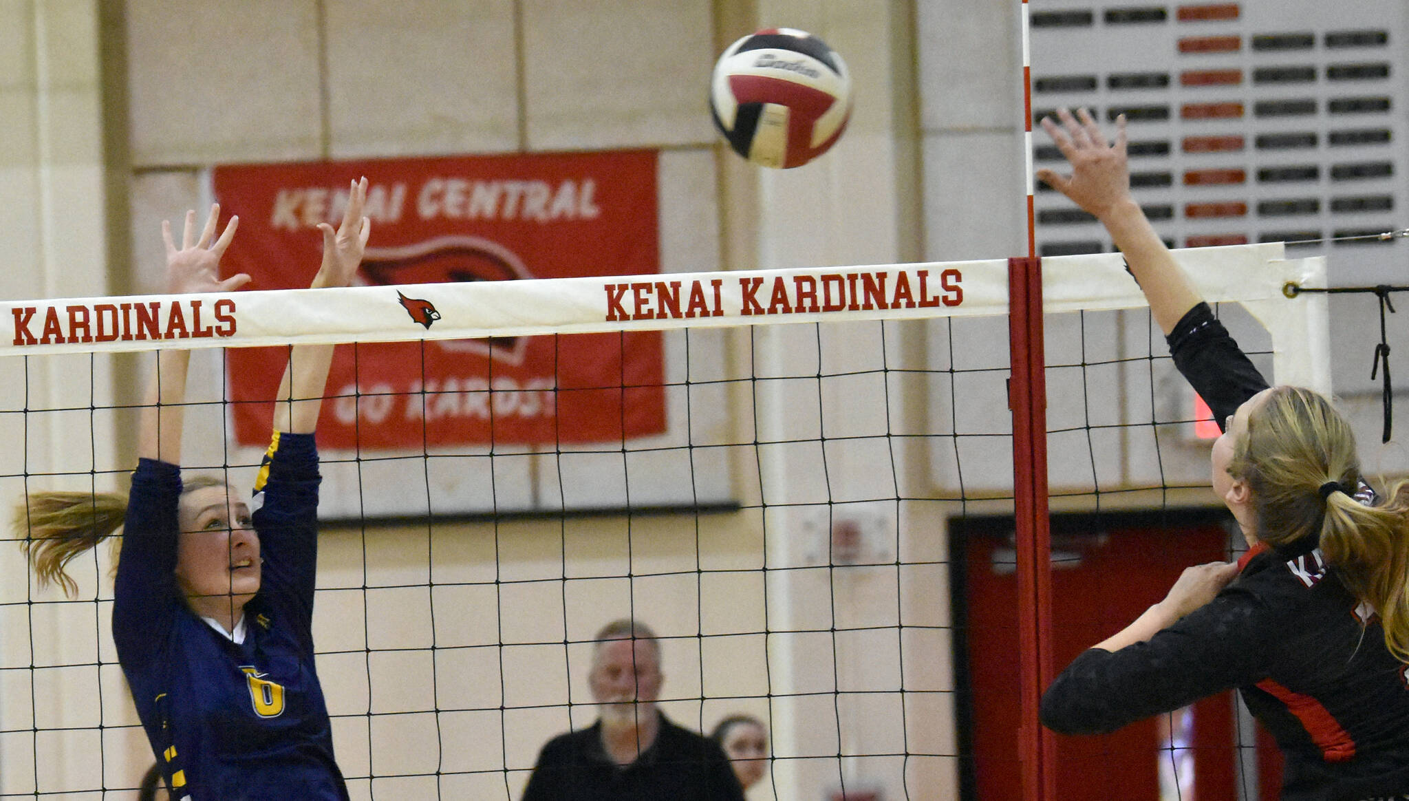 Homer’s Goldie Hill attempts to block the spike of Kenai Central’s Grace Beiser on Friday, Sept. 9, 2022, at Kenai Central High School in Kenai, Alaska. (Photo by Jeff Helminiak/Peninsula Clarion)