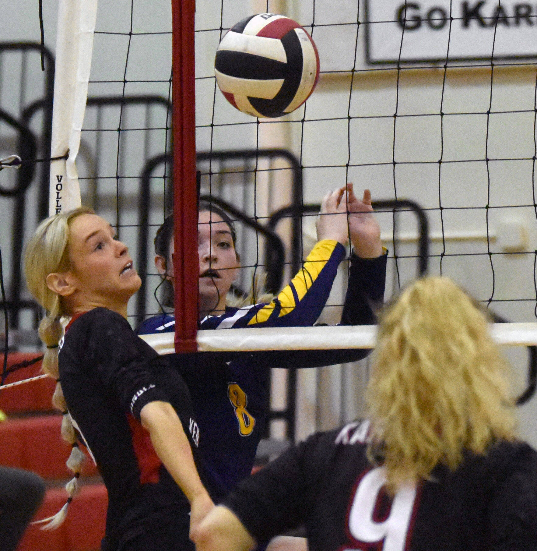 Kenai Central’s Cali Holmes keeps the ball alive in front of Homer’s Brooke Shafer on Friday, Sept. 9, 2022, at Kenai Central High School in Kenai, Alaska. (Photo by Jeff Helminiak/Peninsula Clarion)