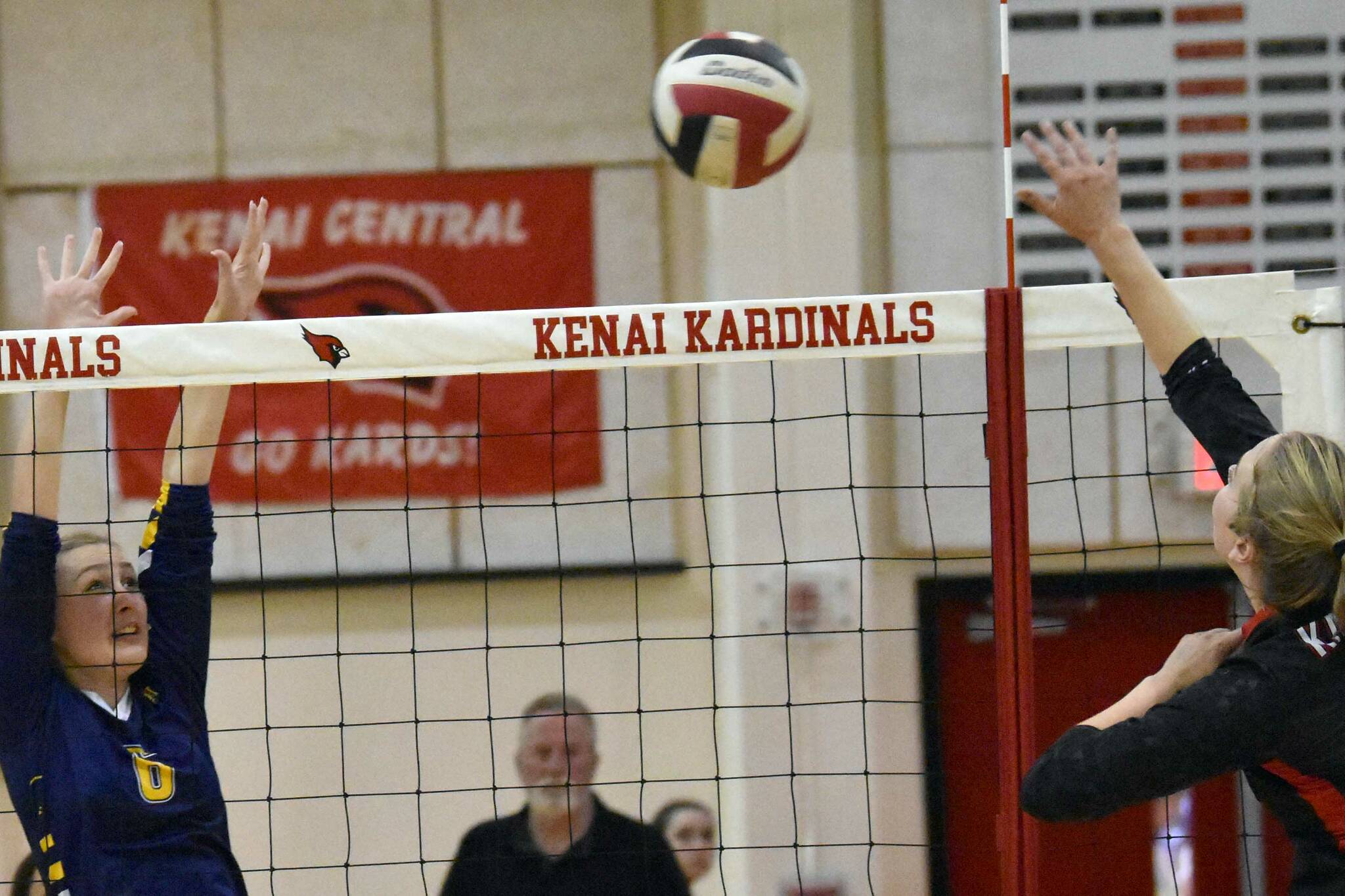 Homer's Goldie Hill attempts to block the spike of Kenai Central's Grace Beiser on Friday, Sept. 9, 2022, at Kenai Central High School in Kenai, Alaska. (Photo by Jeff Helminiak/Peninsula Clarion)