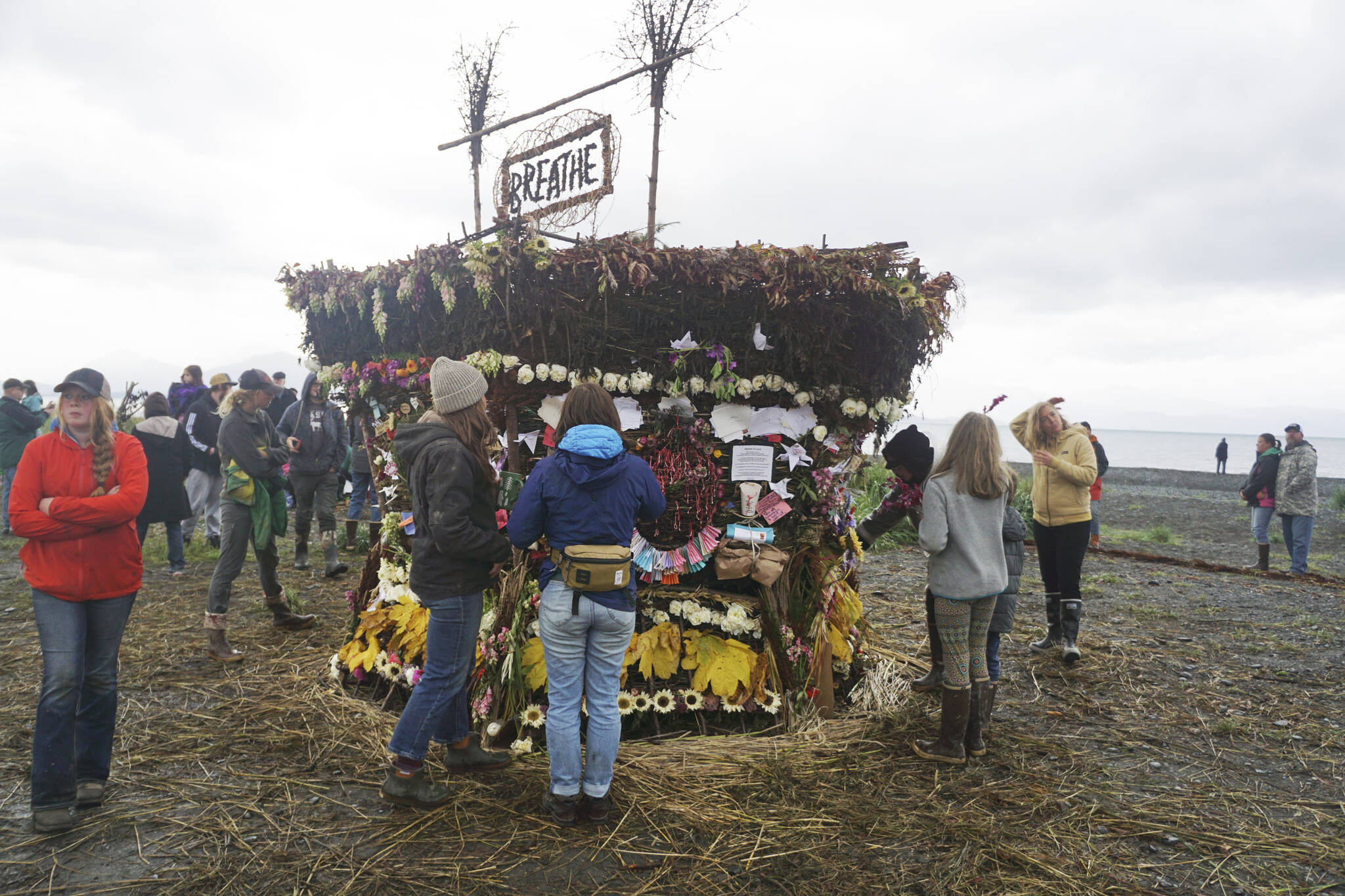 People interact with the 19th annual Burning Basket, “Breathe,” on Sunday, Sept. 11, 2022, at Mariner Park on the Homer Spit in Homer, Alaska. (Photo by Michael Armstrong/Homer News)