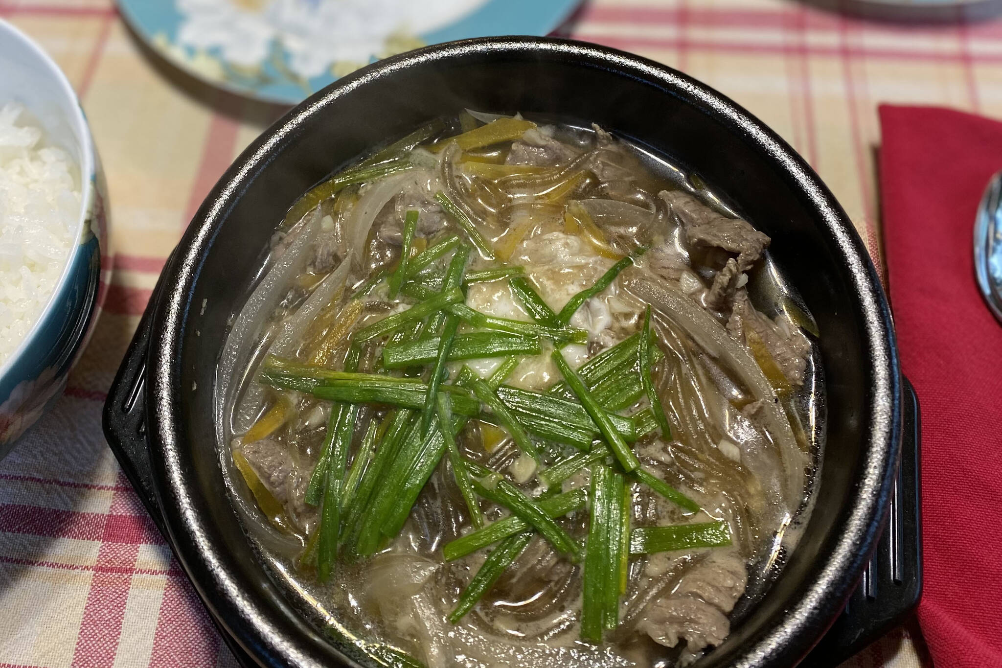 Bulkogi Stew, a mixture of beef steak, potato starch noodles, green onions and broth, is enjoyed as part of the Korean harvest festival, Chuseok. (Photo by Tressa Dale/Peninsula Clarion)