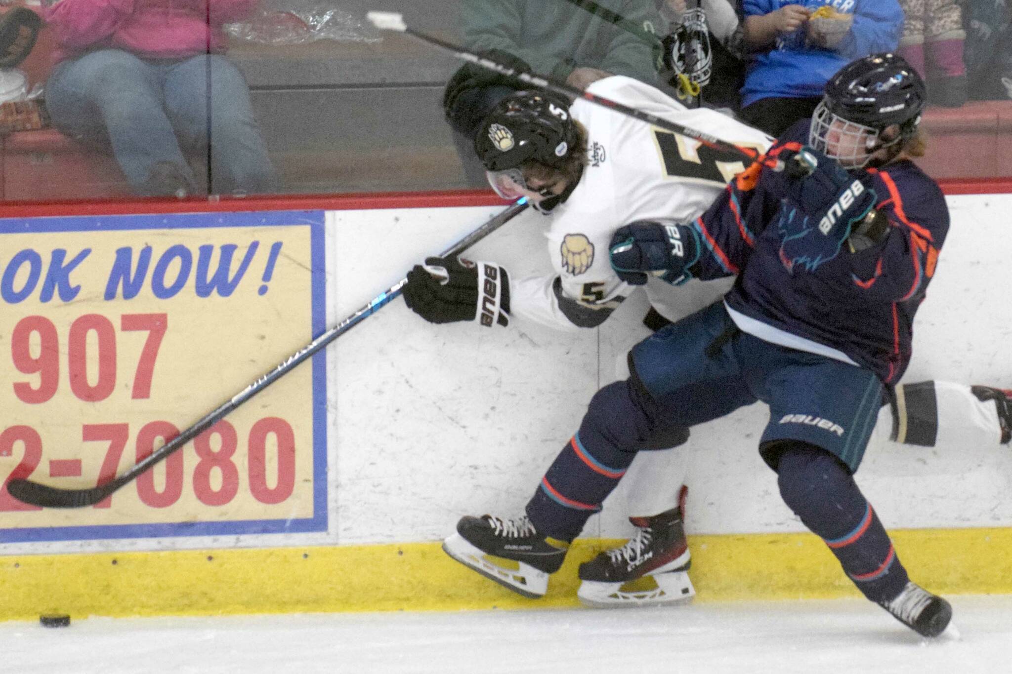 Nick Stevens of the Kenai River Brown Bears tries to squeeze by the check of Bohdan Panasenko of the Anchorage Wolverines on Friday, Dec. 3, 2021, at the Soldotna Regional Sports Complex in Soldotna, Alaska. (Photo by Jeff Helminiak/Peninsula Clarion)