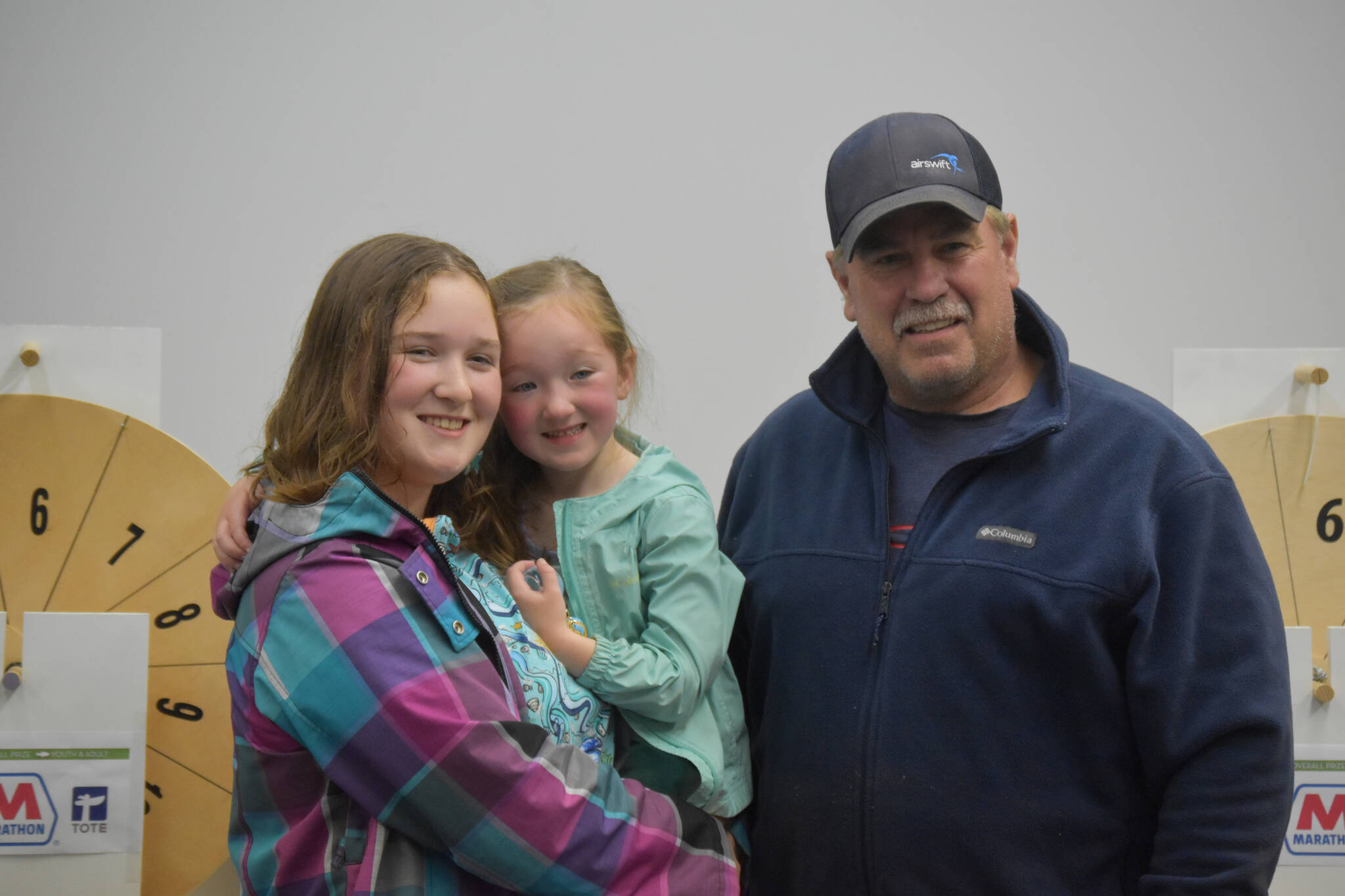 Lily Craig holds her sister, Abigail Craig, who won the youth division of the derby, for photos with Mayor Brian Gabriel on Monday, Sept. 19, 2022, in Kenai. (Jake Dye/Peninsula Clarion)