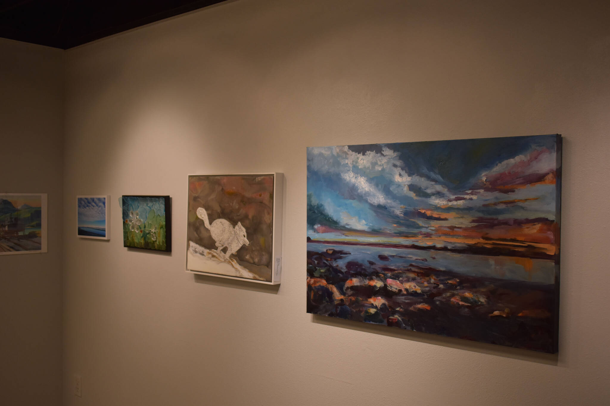 Artwork donated for the Harvest Auction hangs at the Kenai Art Center on Tuesday, Aug. 30, 2022, in Kenai, Alaska. (Jake Dye/Peninsula Clarion)