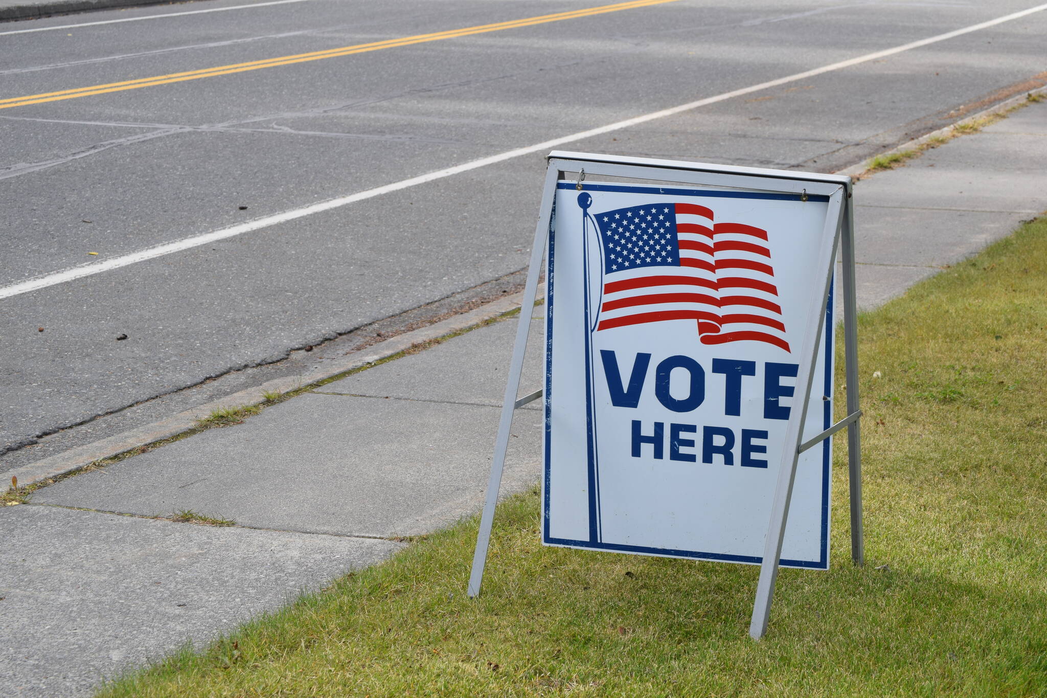 A “Vote Here” sign is seen outside of the City of Kenai Building on Monday, Sept. 21, 2020, in Kenai, Alaska.