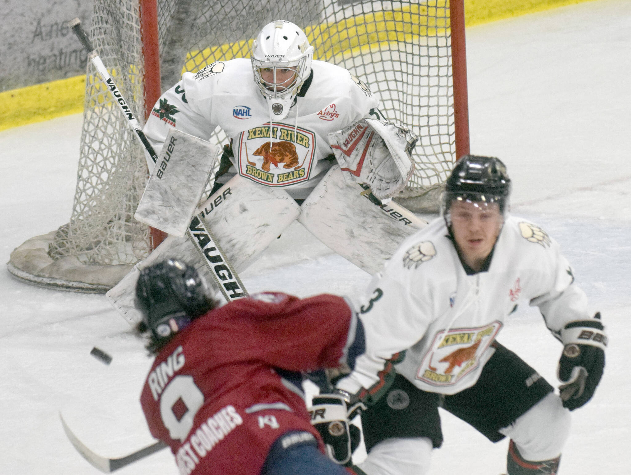 Kenai River Brown Bears goalie Bryant Marks saves a shot by Jack Ring of the Fairbanks Ice Dogs on Friday, March 12, 2022, at the Soldotna Regional Sports Complex in Soldotna, Alaska. (Photo by Jeff Helminiak/Peninsula Clarion)