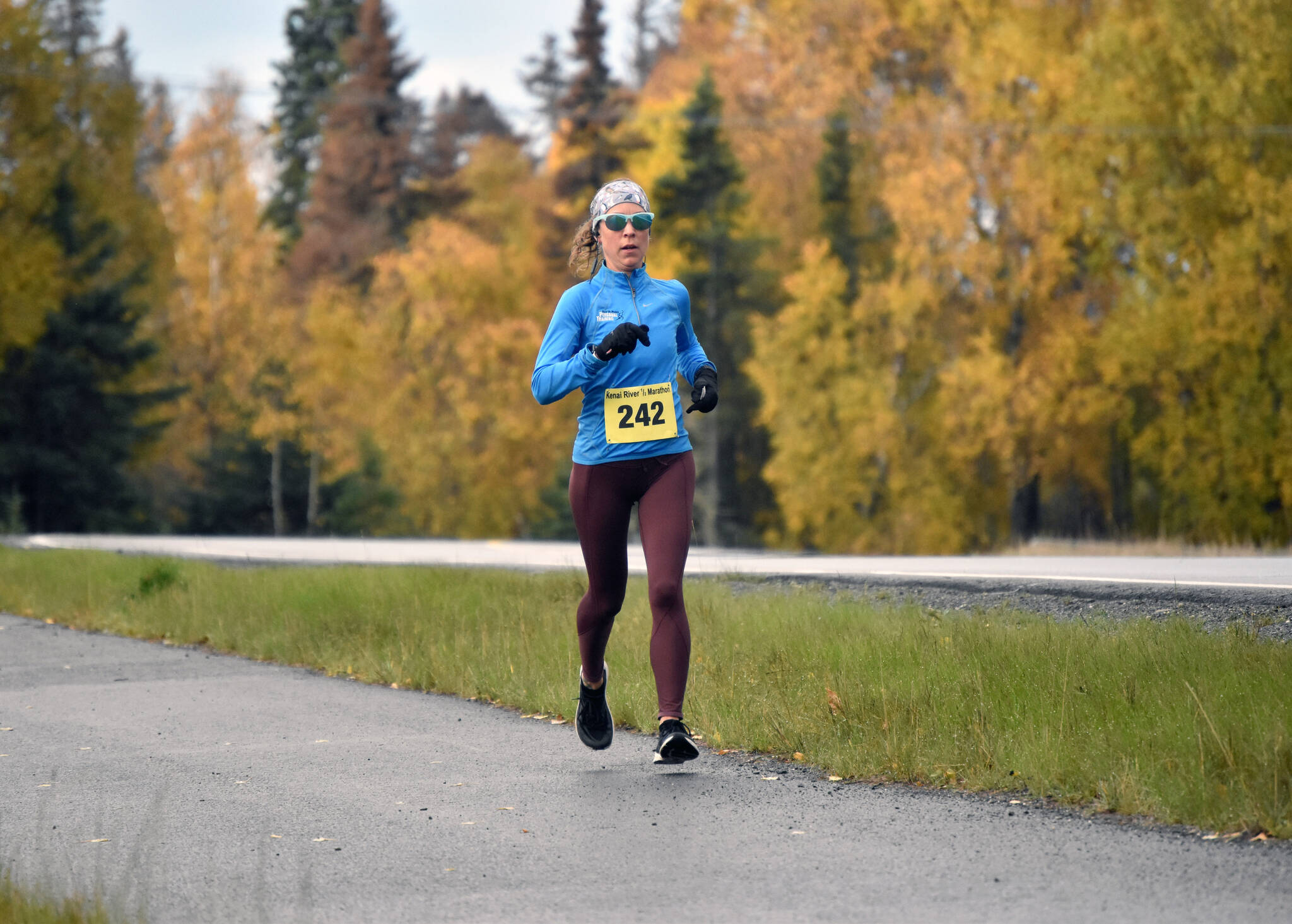 Kristin Davis runs to victory in the women’s half marathon in the Kenai River Marathon on Sunday, Sept. 25, 2022, in Kenai, Alaska. (Photo by Jeff Helminiak/Peninsula Clarion)
