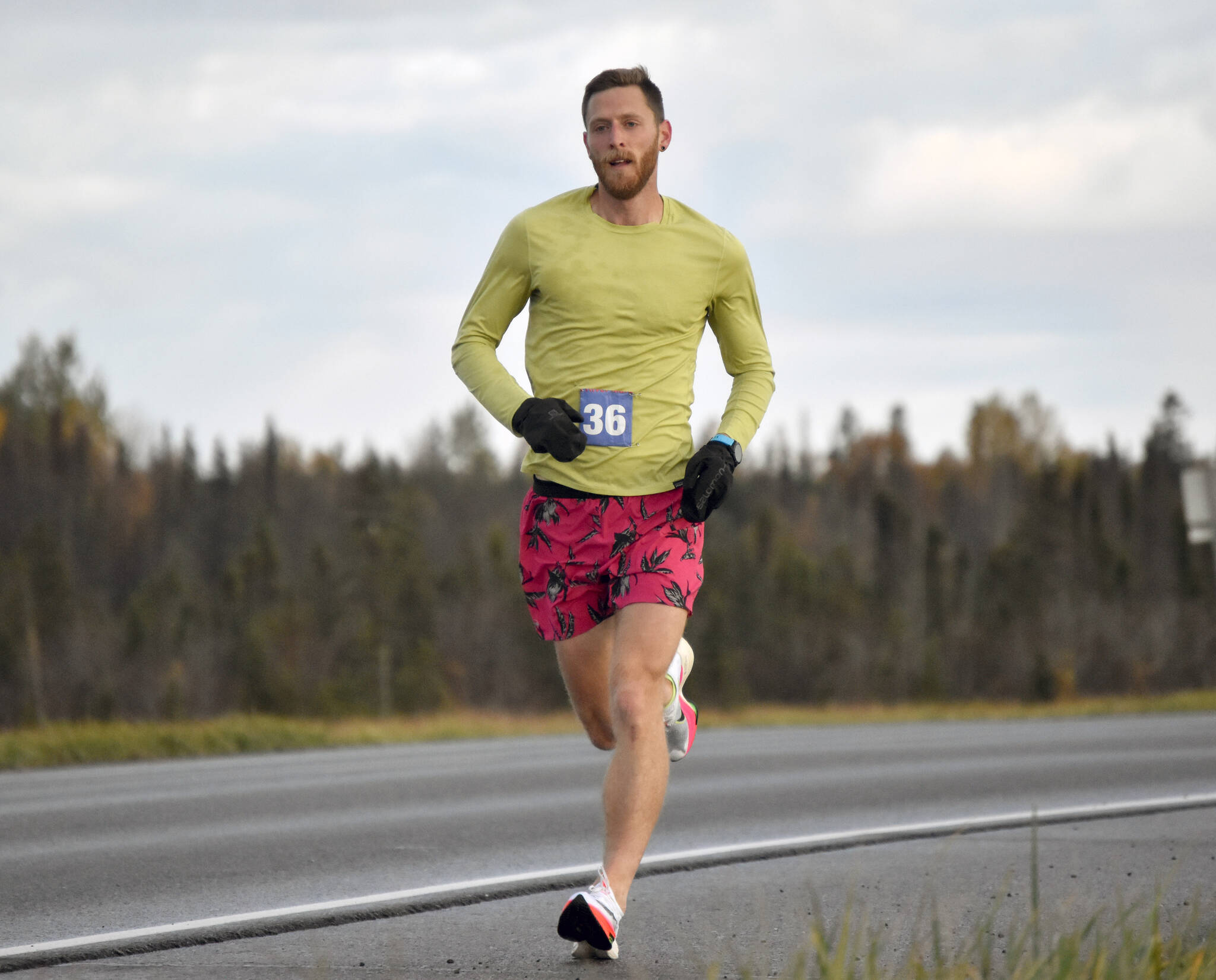 Lars Arneson runs to a victory and new event record in the Kenai River Marathon on Sunday, Sept. 25, 2022, in Kenai, Alaska. (Photo by Jeff Helminiak/Peninsula Clarion)
