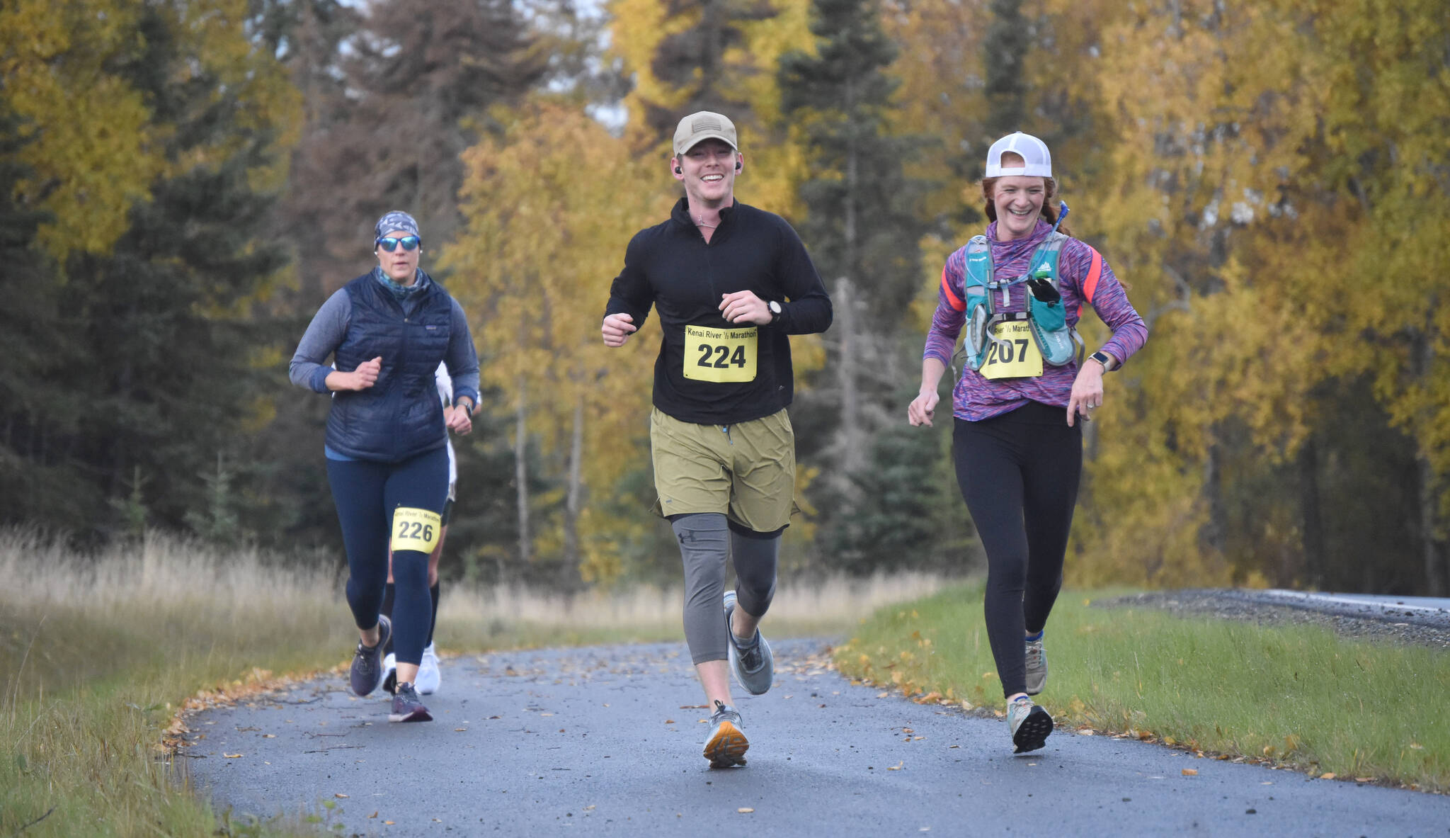 Megan Murphy, Cason Hucks and Allison Reeves run in the half marathon at the Kenai River Marathon on Sunday, Sept. 25, 2022, in Kenai, Alaska. (Photo by Jeff Helminiak/Peninsula Clarion)