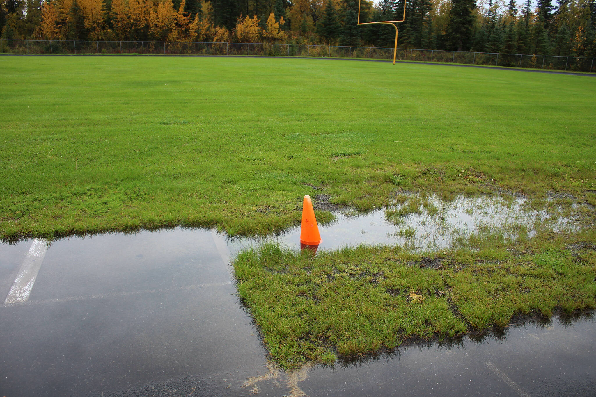 Water pools in a track and field long jump sandpit at Nikiski Middle/High School on Monday, Sept. 19, 2022, in Nikiski, Alaska. The track is one of several projects in a bond package Kenai Peninsula voters will consider during the Oct. 4 municipal election next month. (Ashlyn O’Hara/Peninsula Clarion)