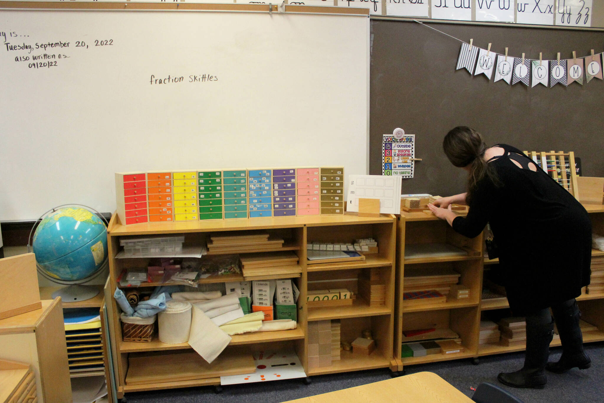 Teacher April Dixon adjusts Montessori materials in a classroom at Soldotna Montessori Charter School on Tuesday, Sept. 20, 2022, in Soldotna, Alaska. (Ashlyn O’Hara/Peninsula Clarion)