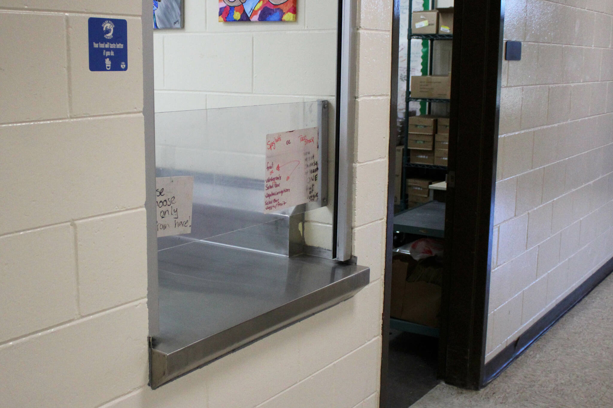 Notes are affixed to the cafeteria window, through which Principal Vaughn Dosko estimates 60% of students are given meals every day, at Kenai Middle School on Wednesday, Sept. 21, 2022, in Kenai, Alaska. (Ashlyn O’Hara/Peninsula Clarion)