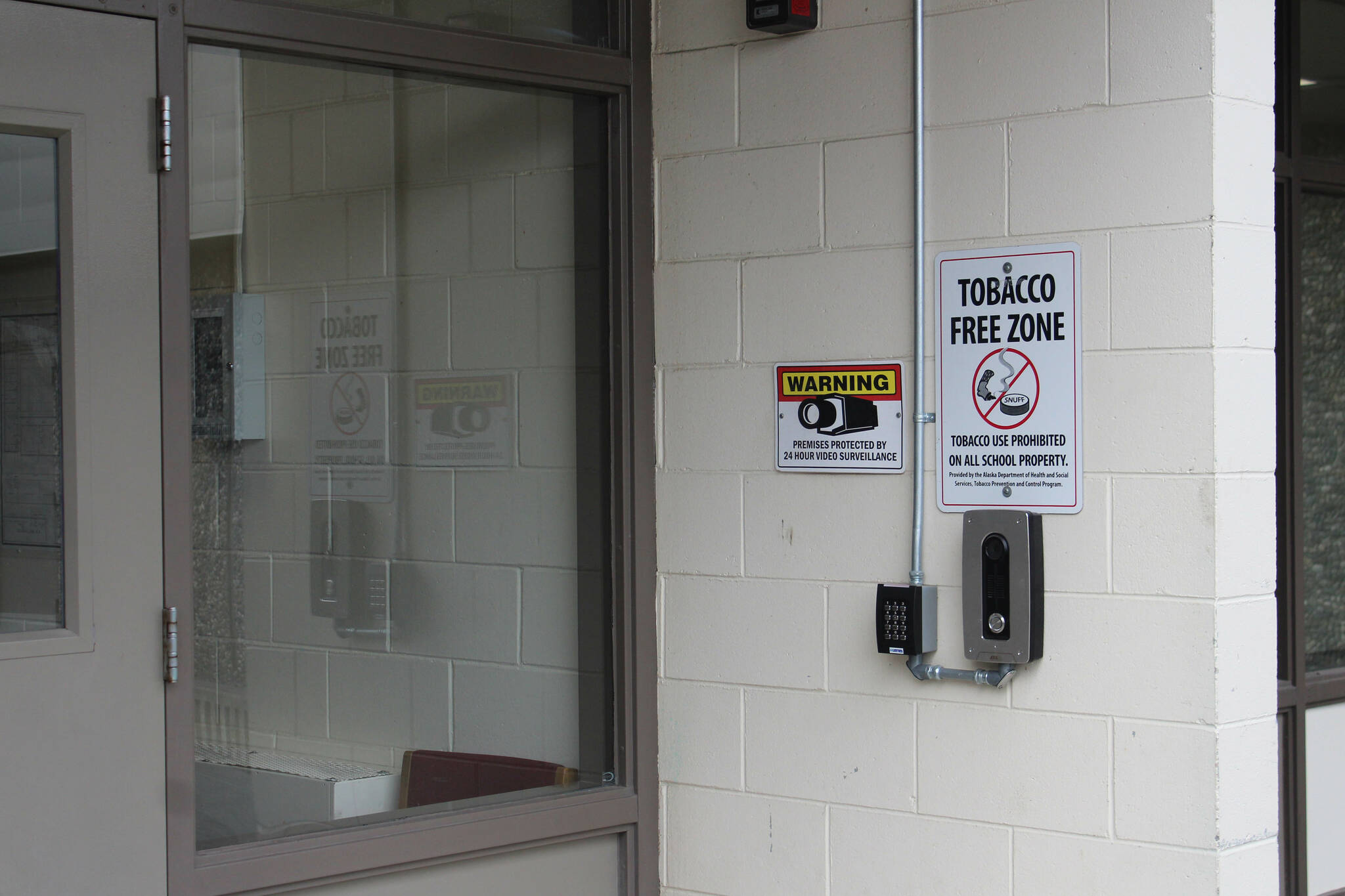 A camera and doorbell are mounted outside of the entrance to Kenai Middle School on Wednesday, Sept. 21, 2022, in Kenai, Alaska. (Ashlyn O’Hara/Peninsula Clarion)