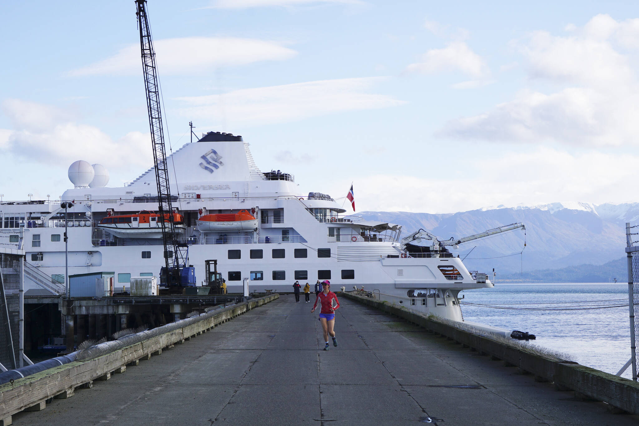 A jogger leaves the Silversea cruise ship Silver Wind at the Deep Water Dock on Sunday, Sept. 25, 2022, in Homer, Alaska. (Photo by Michael Armstrong/Homer News)