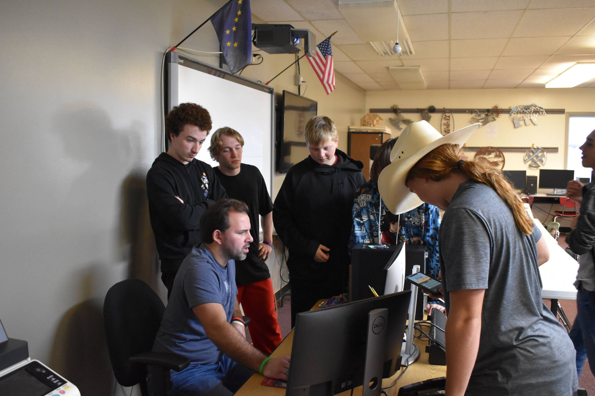 Members of Kenai Central High School Esports gather around coach Shane Lopez before their League of Legends match Tuesday, Sept. 27, 2022, at Kenai Central High School in Kenai, Alaska. (Jake Dye/Peninsula Clarion)