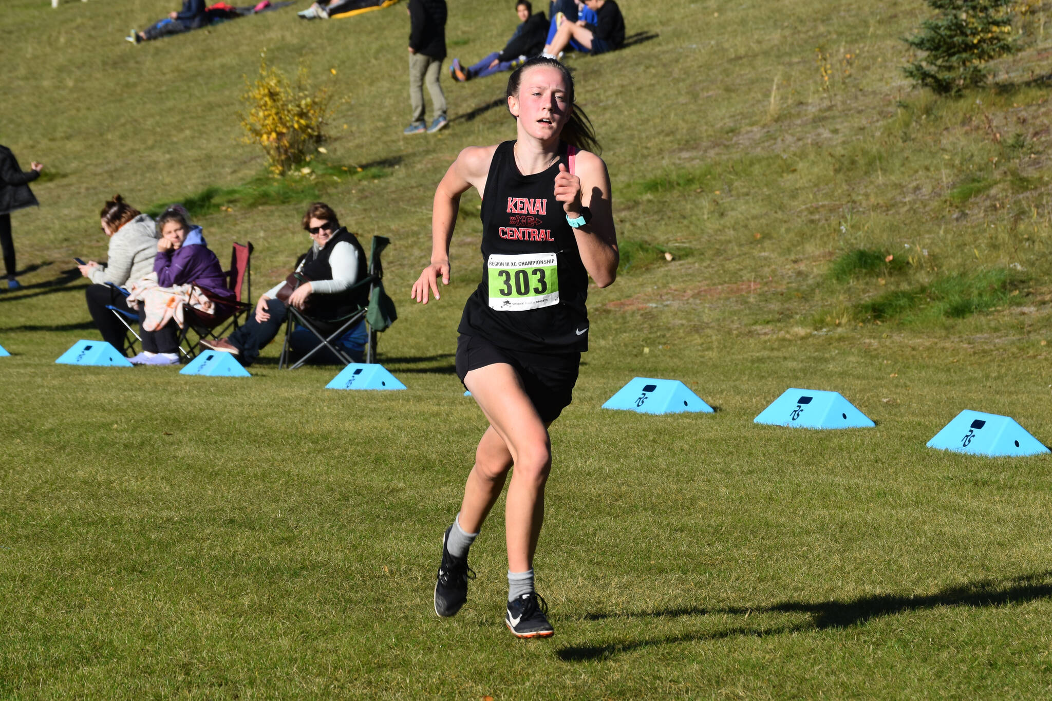 Kenai’s Jayna Boonstra runs down the last stretch to the finish chute during the Region 3/Division II girls race on Saturday, Oct. 1, 2022 at Tsalteshi Trails just outside of Soldotna, Alaska. (Jake Dye/Peninsula Clarion)