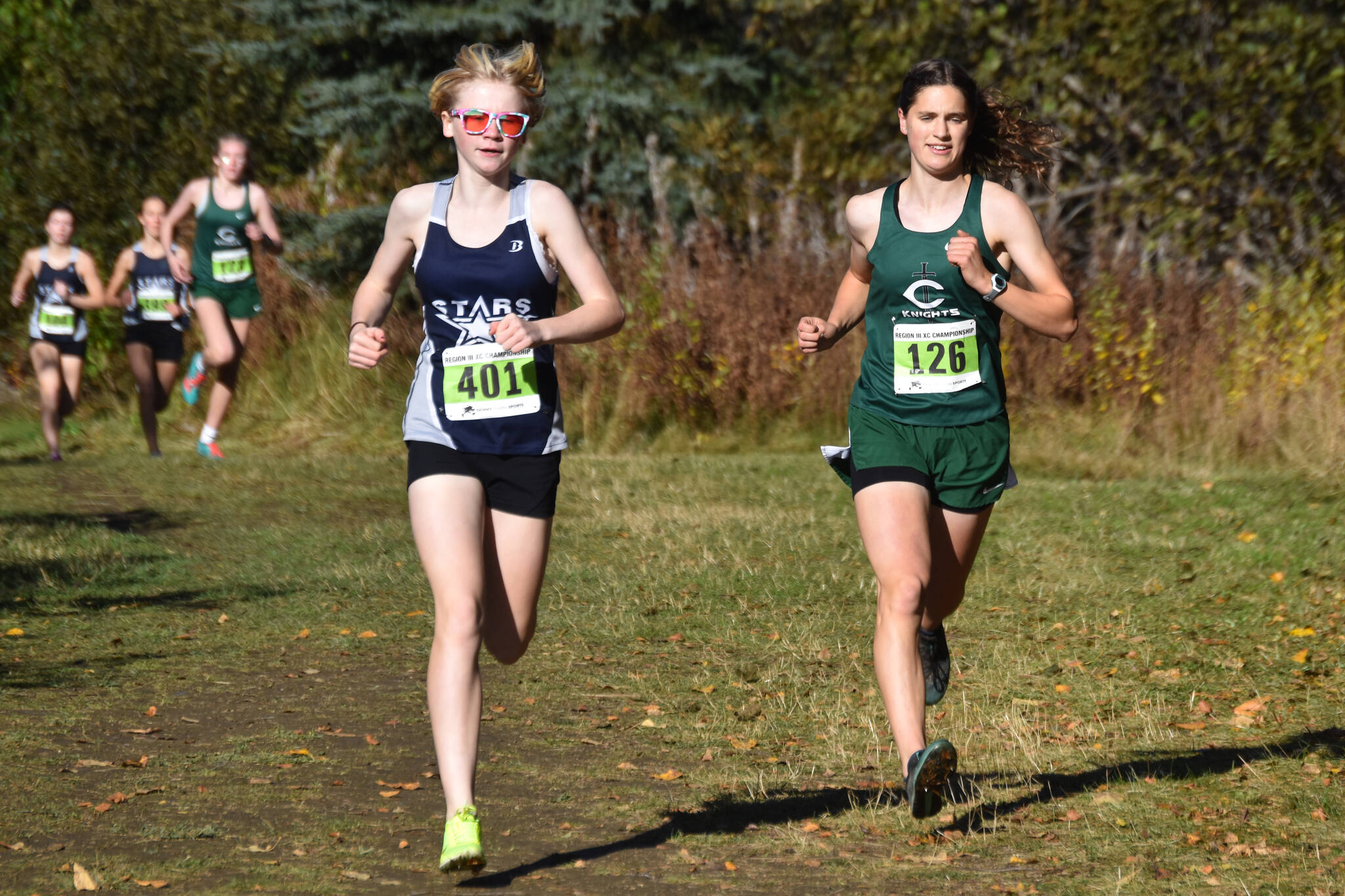 Soldotna’s Sophia Jedlicki and Colony’s Ella Hopkins race side by side during the Region 3/Division I girls race on Saturday, Oct. 1, 2022 at Tsalteshi Trails just outside of Soldotna, Alaska. (Jake Dye/Peninsula Clarion)
