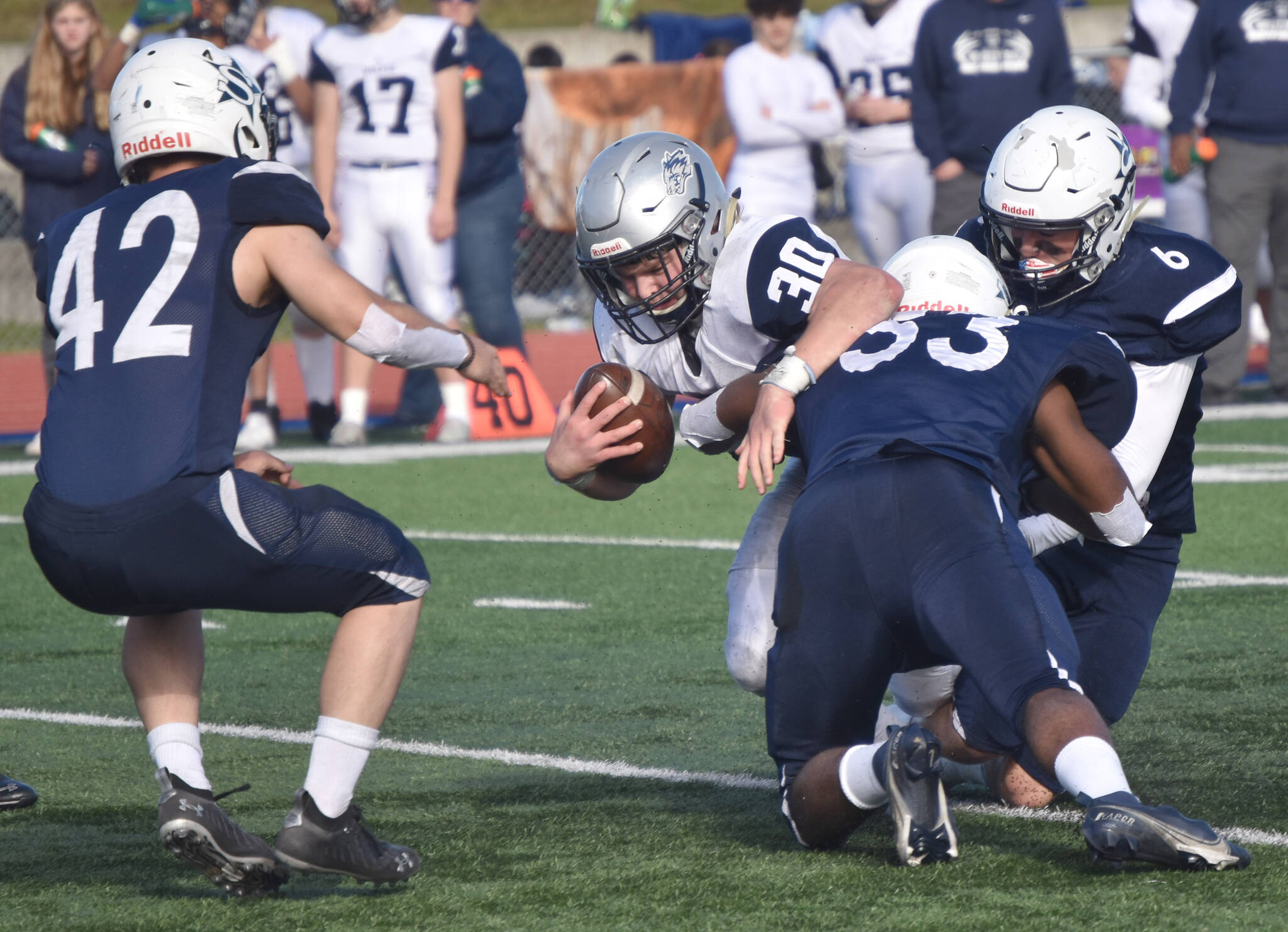 Eagle River’s Aiden Roschi is stopped by Soldotna’s Jakob Kemp, Elijah Lee and Trevor Michael on Saturday, Oct. 1, 2022, at Justin Maile Field at Soldotna High School in Soldotna, Alaska. (Photo by Jeff Helminiak/Peninsula Clarion)