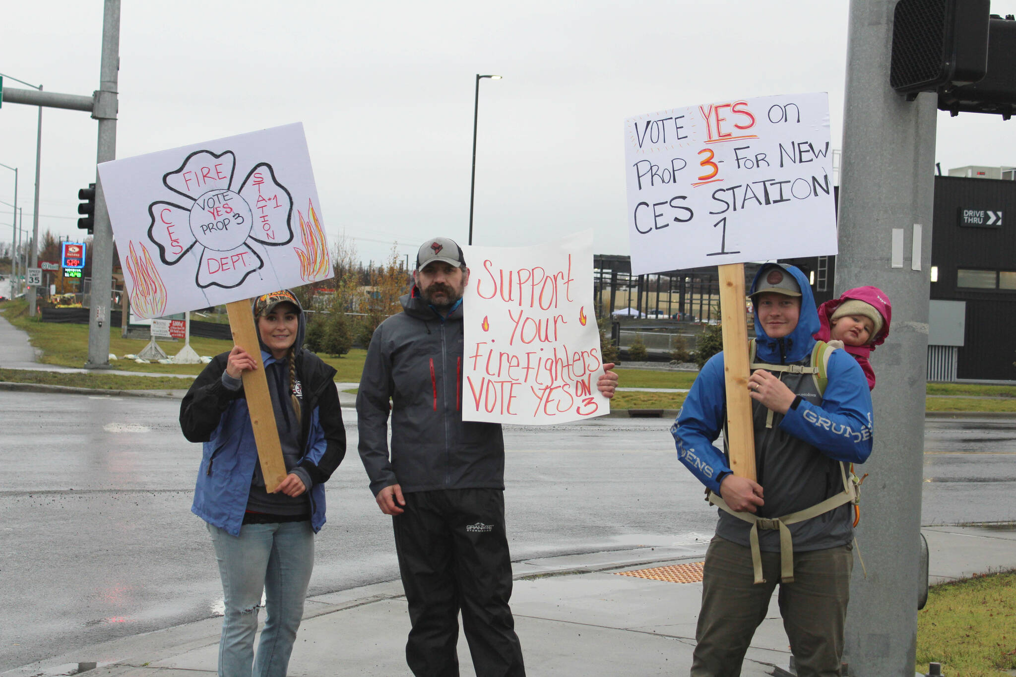 From left, Becca Satathite, Joshua Thompson, Spencer McLean and Emma McLean waive signs in support of Proposition 3 at the intersection of the Kenai Spur and Sterling Highways on Tuesday, Oct. 4, 2022, in Soldotna, Alaska. (Ashlyn O’Hara/Peninsula Clarion)