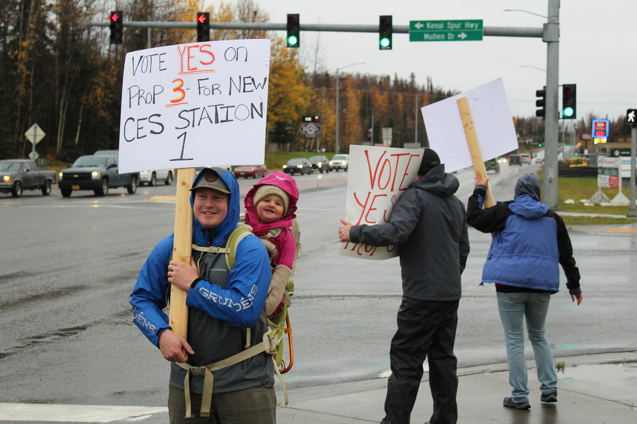 Spencer McLean and his daughter, Emma McLean, show their support for Proposition 3, through which a new CES Station 1 would be constructed in Soldotna, on Tuesday, Oct. 4, 2022, in Soldotna, Alaska. (Ashlyn O’Hara/Peninsula Clarion)