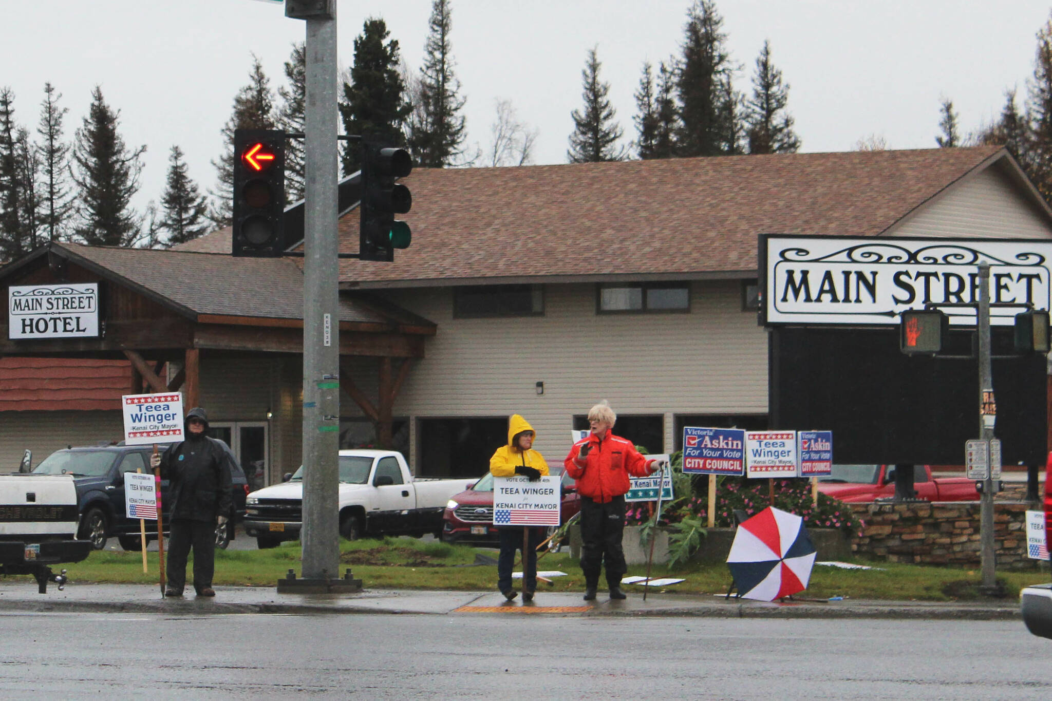 People waive political signs at the intersection of Bridge Access Road and the Kenai Spur Highway on Tuesday, Oct. 4, 2022, in Kenai, Alaska. (Ashlyn O’Hara/Peninsula Clarion)