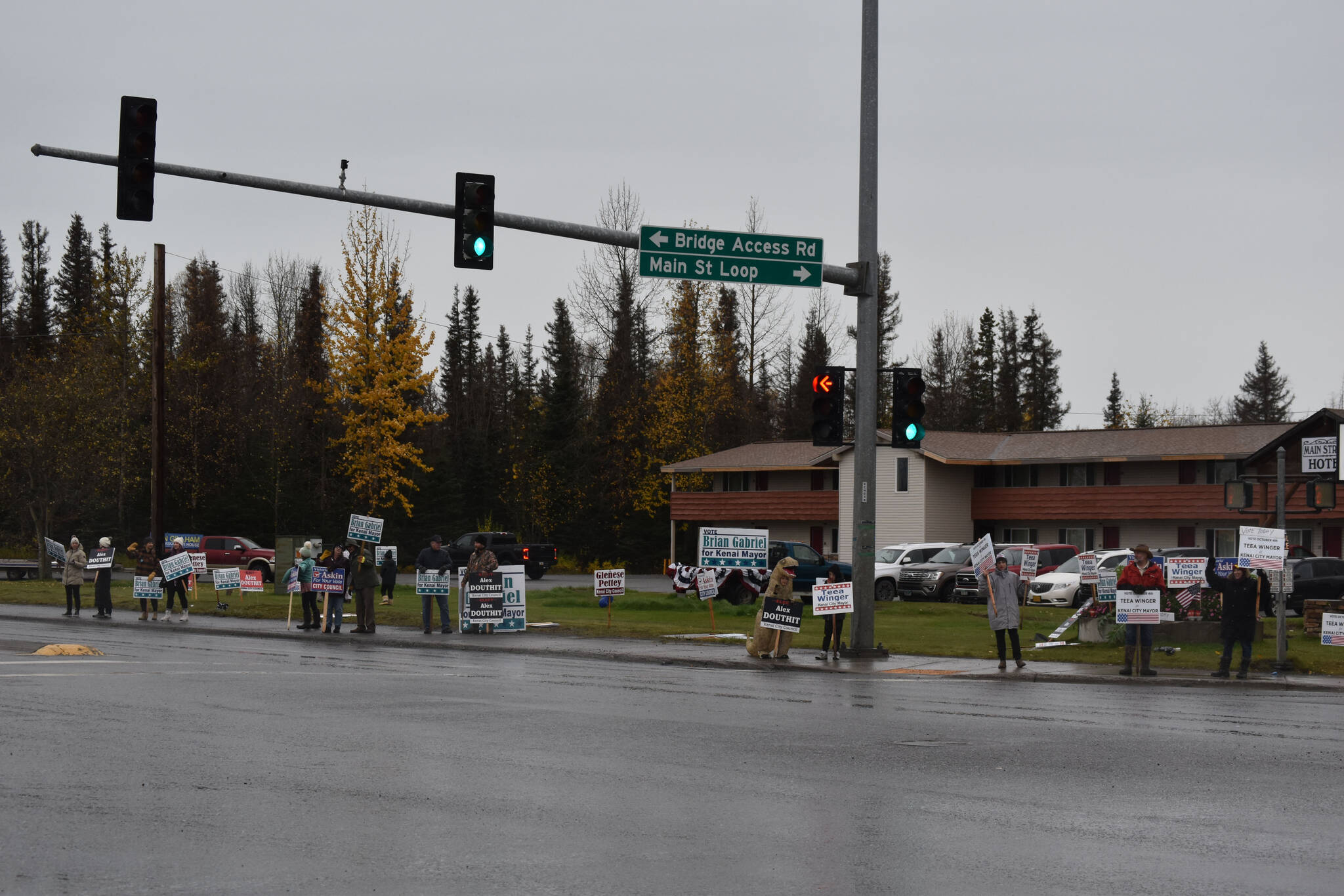Sign wavers line the corner of the Kenai Spur Highway and Bridge Access Road on Election Day, Oct. 4, 2022 in Kenai, Alaska. (Jake Dye/Peninsula Clarion)