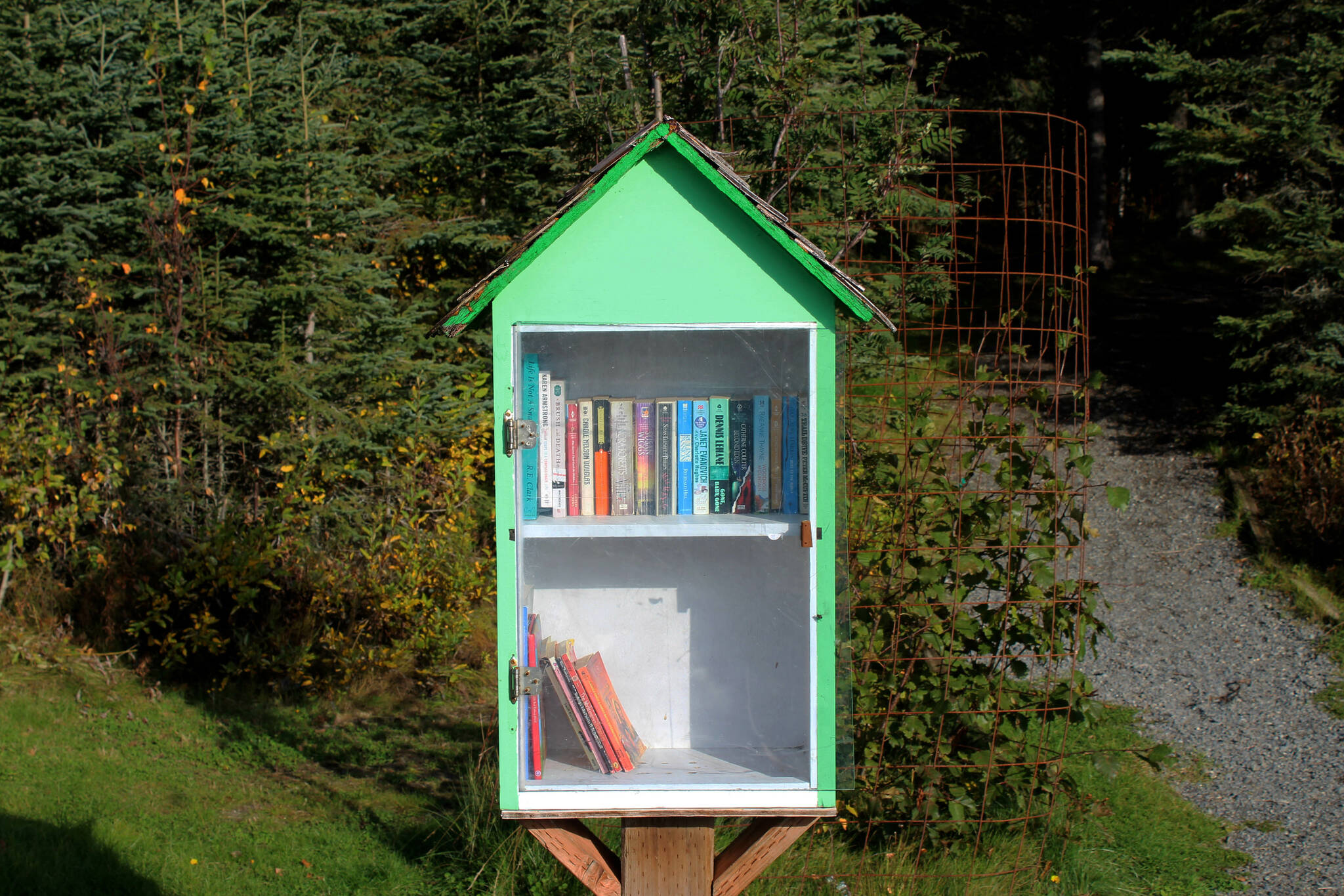 A mini-library contains books at Daubnespeck Park on Monday, Oct. 3, 2022, in Kenai, Alaska. (Ashlyn O’Hara/Peninsula Clarion)