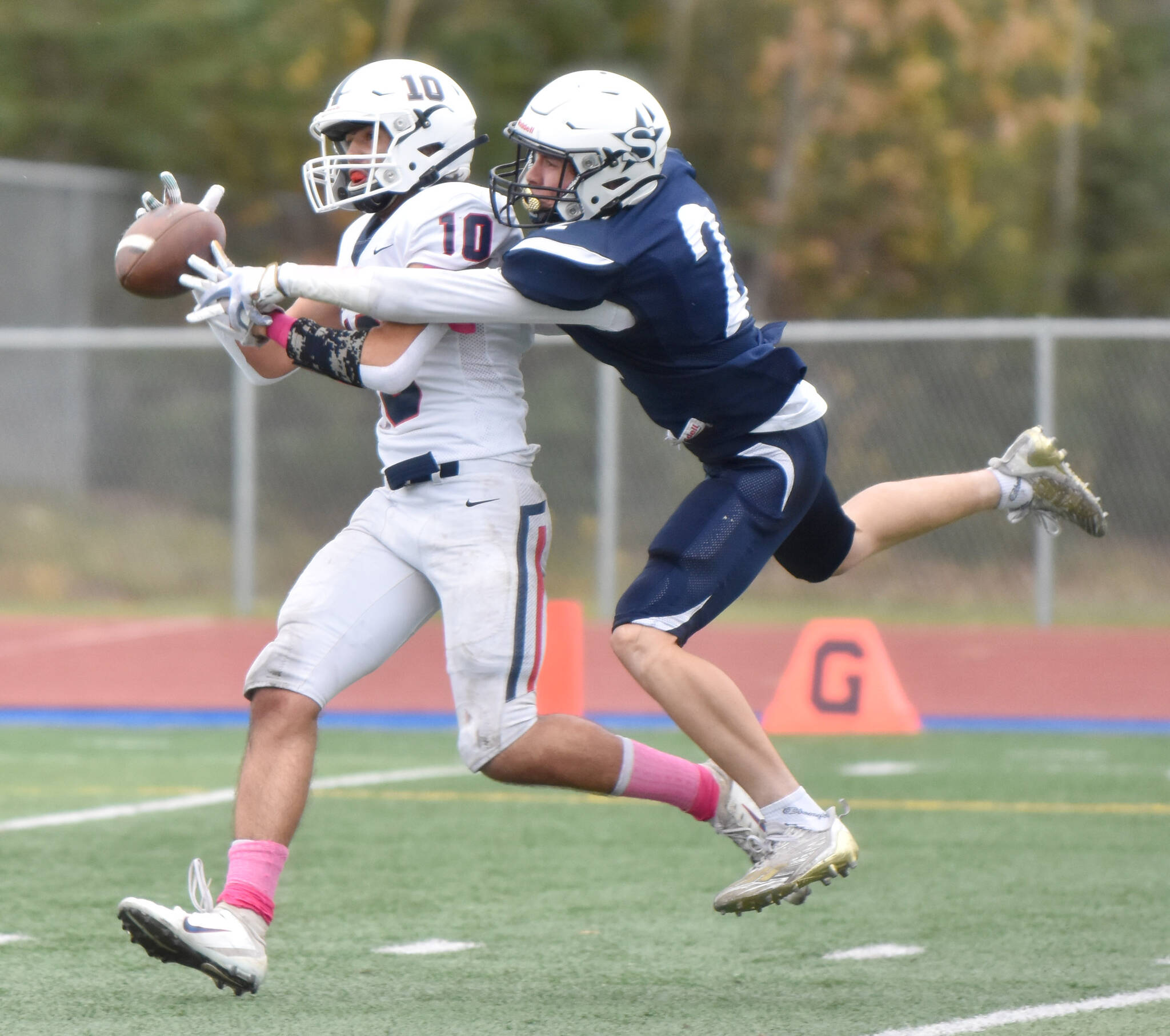 Soldotna’s Leigh Tacey breaks up a pass for North Pole’s Logan Fischer on Friday, Oct. 7, 2022, at Justin Maile Field at Soldotna High School in Soldotna, Alaska. (Photo by Jeff Helminiak/Peninsula Clarion)