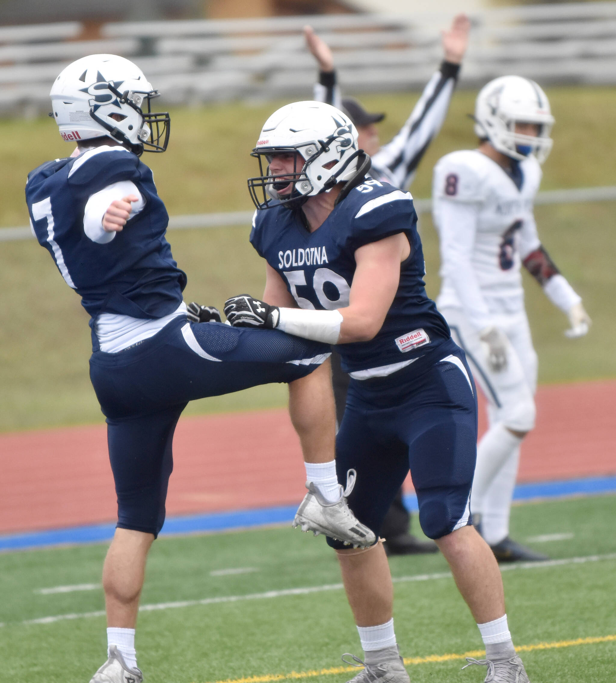 Zac Buckbee and Joe Whittom celebrate after Buckbee’s touchdown run in the first quarter Friday, Oct. 7, 2022, at Justin Maile Field at Soldotna High School in Soldotna, Alaska. (Photo by Jeff Helminiak/Peninsula Clarion)