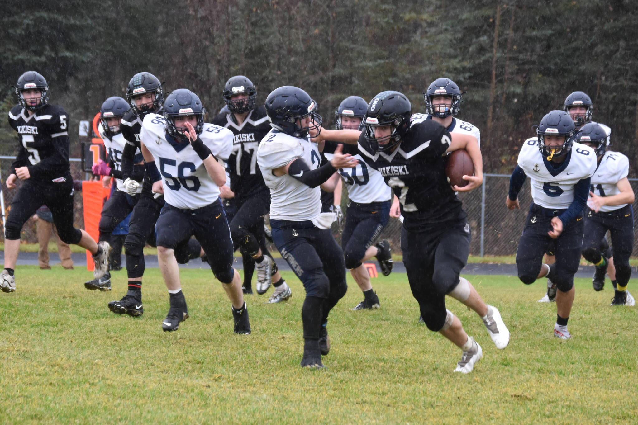 Nikiski’s Dwyght Mullins fends off Homer’s Chris Martishev during the playoff game on Saturday, Oct. 8, 2022, at Nikiski Middle/High School in Nikiski, Alaska. (Jake Dye/Peninsula Clarion)