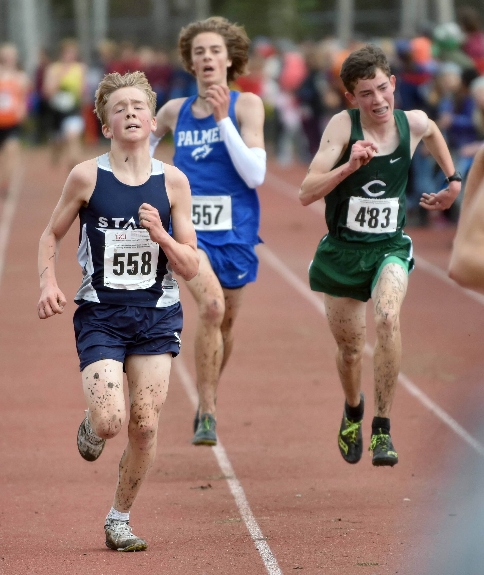 Soldotna’s Jacob Strausbaugh, Palmer’s Tobin Miller and Colony’s Coby Marvin sprint for the finish in the Division I boys race at the state cross-country meet Saturday, Oct. 8, 2022, at Bartlett High School in Anchorage, Alaska. (Photo by Jeff Helminiak/Peninsula Clarion)