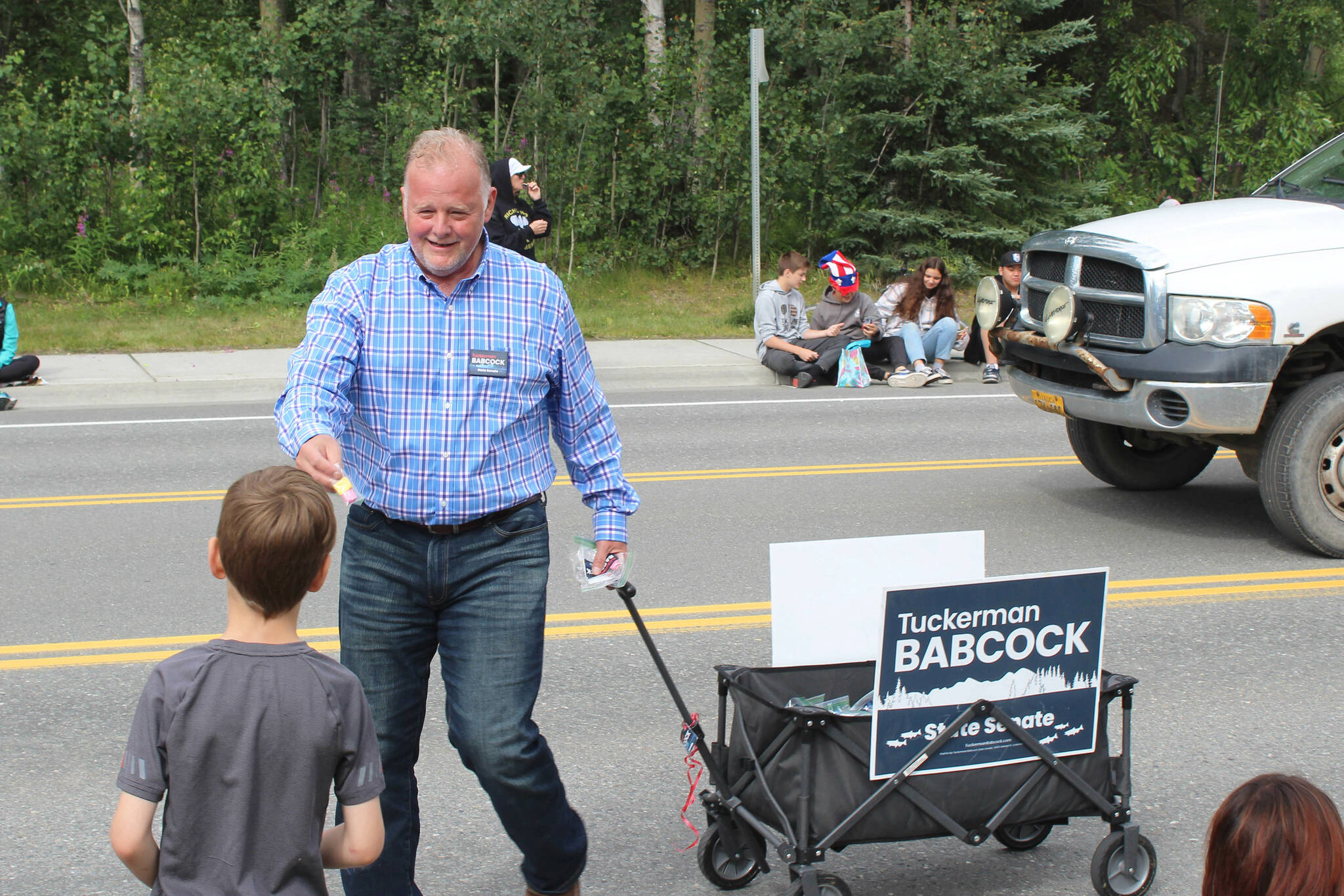 2022 Alaska State Senate candidate Tuckerman Babcock hands out candy during the 65th annual Soldotna Progress Days Parade on Saturday, July 23, 2022, in Soldotna, Alaska. (Ashlyn O’Hara/Peninsula Clarion)