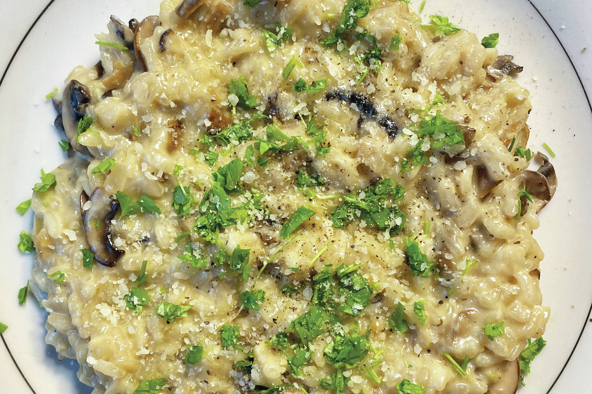 Mild and comforting wild mushroom risotto is stirred slowly as stock and mushrooms are added. (Photo by Tressa Dale/Peninsula Clarion)