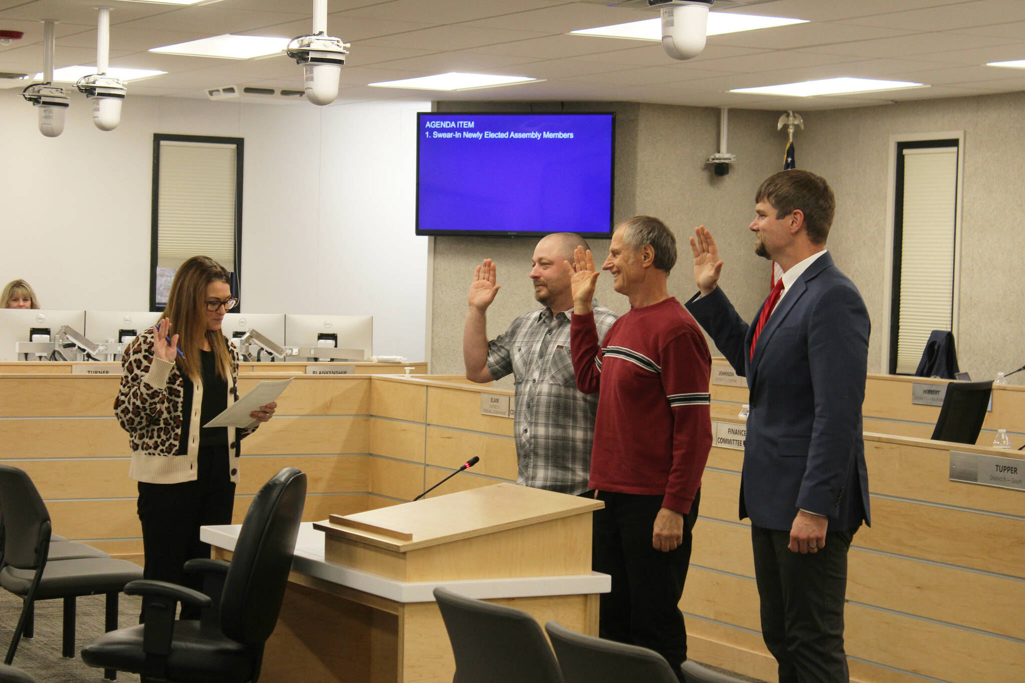 From left: Kenai Peninsula Borough Clerk Johni Blankenship swears in newly reelected assembly members Tyson Cox, Brent Johnson and Jesse Bjorkman during a meeting on Tuesday, Oct. 11, 2022. (Ashlyn O’Hara/Peninsula Clarion)