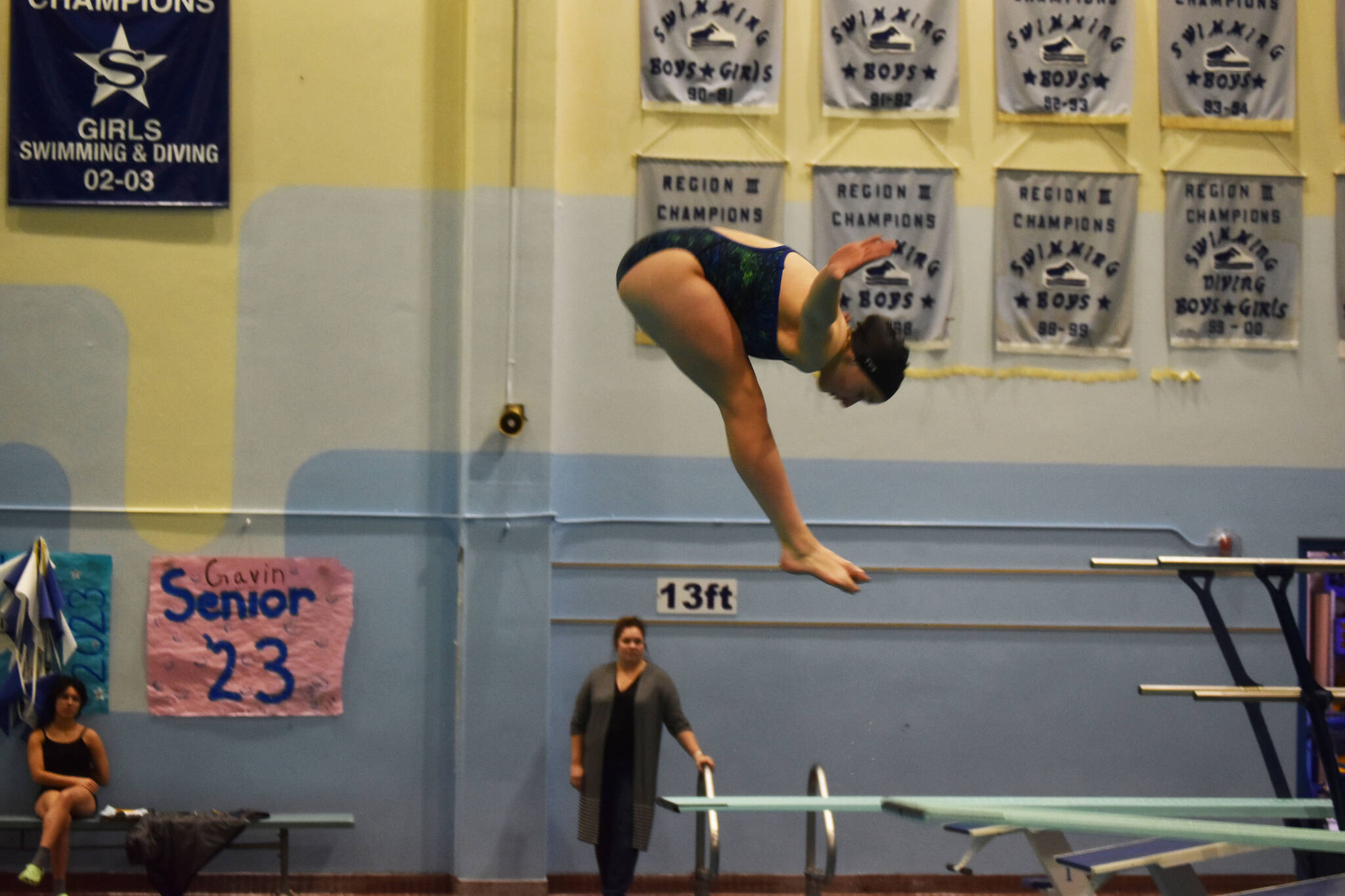 Abriella Werner performs a reverse dive during a practice on Tuesday, Oct. 11, 2022 at Soldotna High School in Soldotna, Alaska. (Jake Dye/Peninsula Clarion)