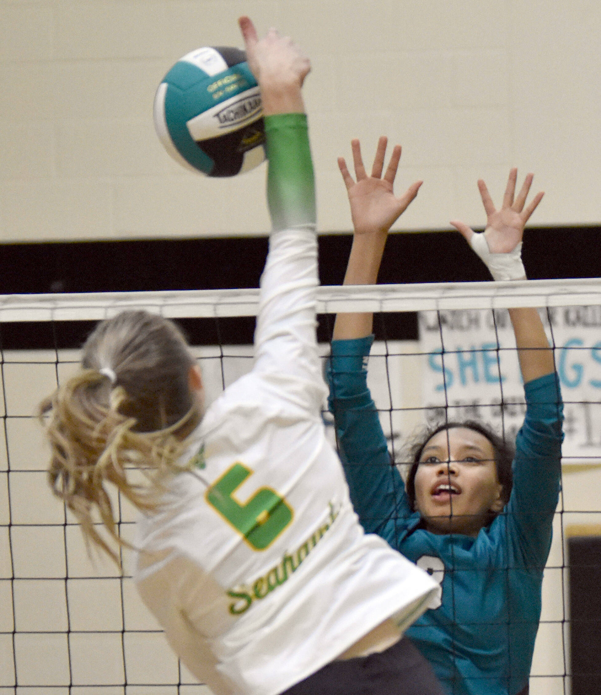 Nikiski’s Alexa Iyatunguk puts up a block on Seward’s Renee Elhard on Thursday, Oct. 13, 2022, at Nikiski High School in Nikiski, Alaska. (Photo by Jeff Helminiak/Peninsula Clarion)