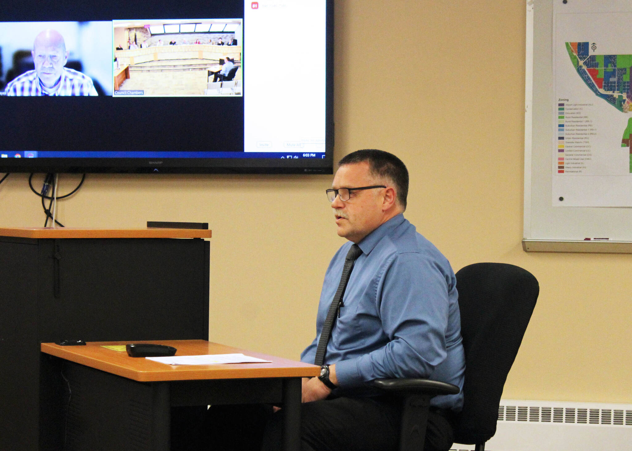 Oregon Accreditation Alliance Executive Director Scott Hayes, monitor, and Kenai Police Chief David Ross, right, field questions from the Kenai City Council regarding the department’s accreditation during a council meeting on Wednesday, Oct. 5, 2022, in Kenai, Alaska. (Ashlyn O’Hara/Peninsula Clarion)